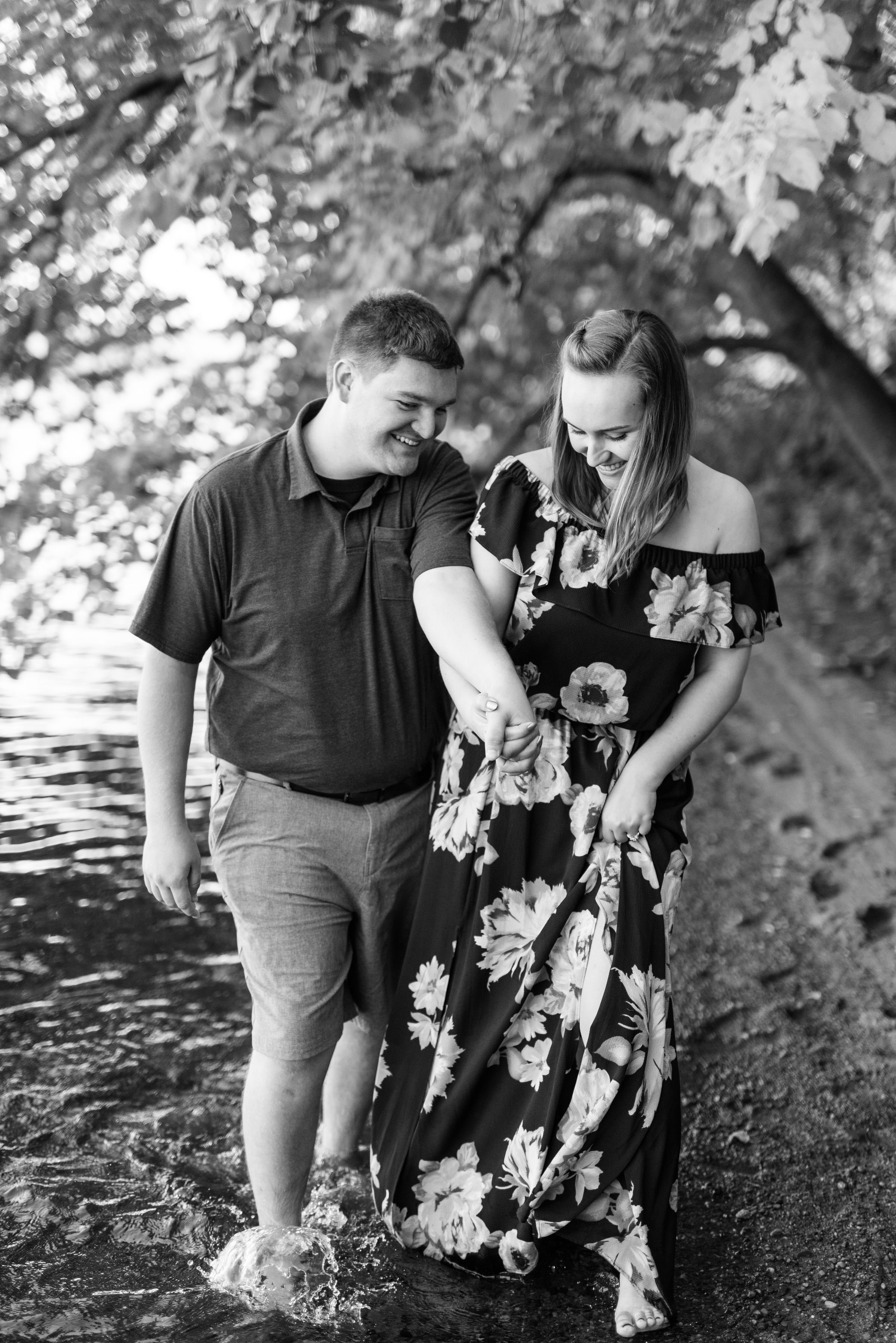 EngagedCoupleWalkingInRiverEauClaireWI.jpeg