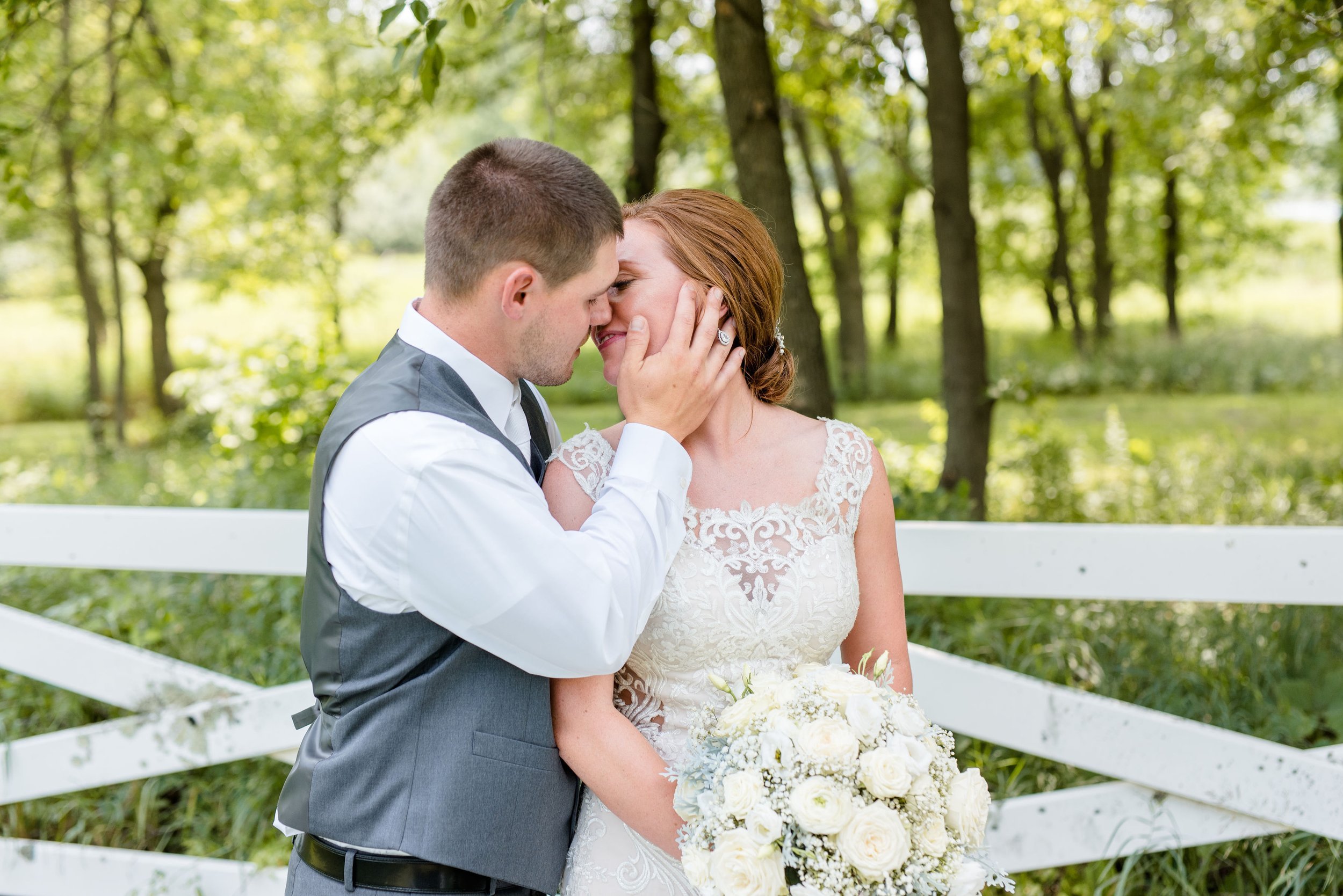 Erickson Farmstead Summer Wedding Bride and Groom Share a Kiss.jpeg