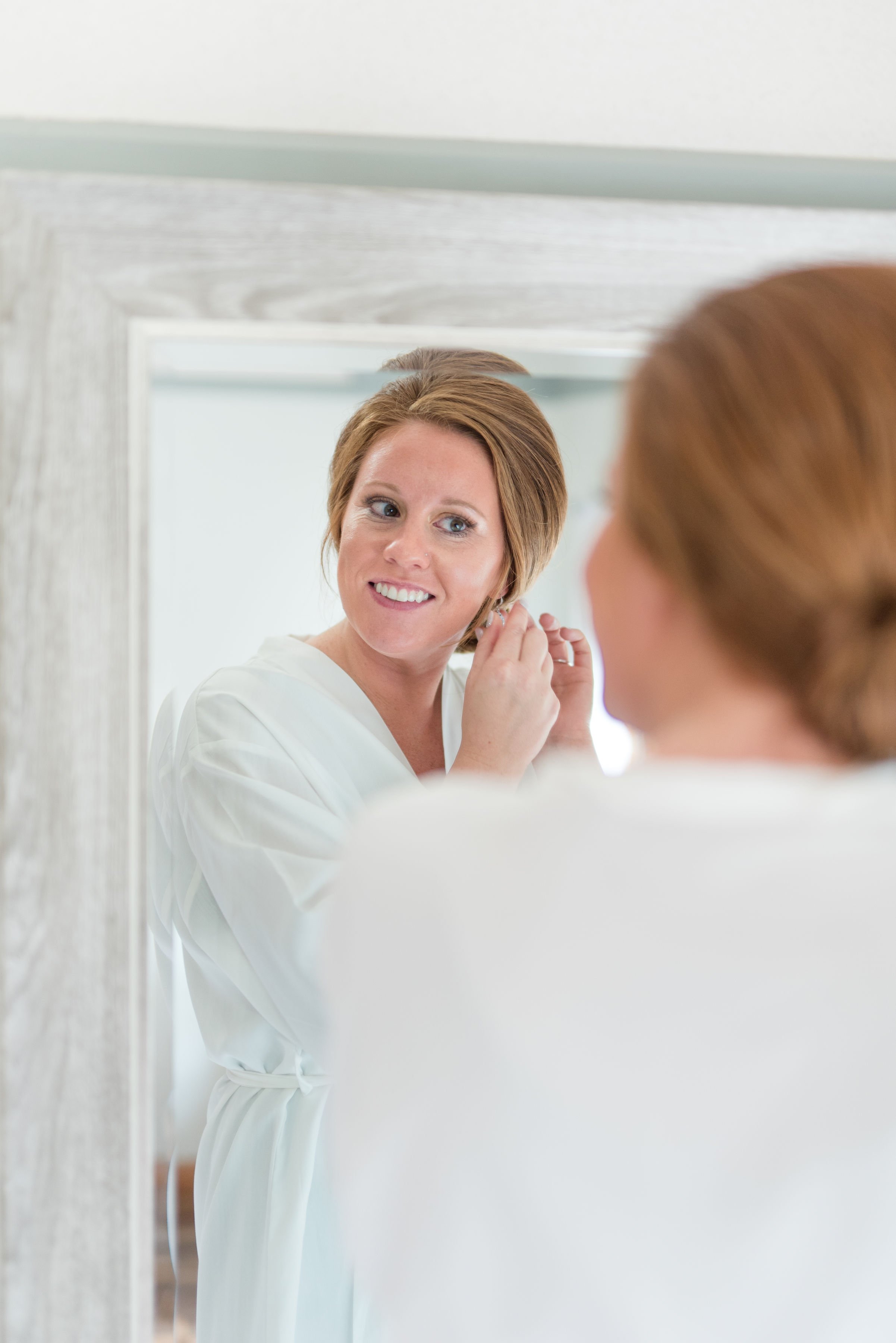 Erickson Farmstead Summer Wedding Bride Getting Dressed.jpeg