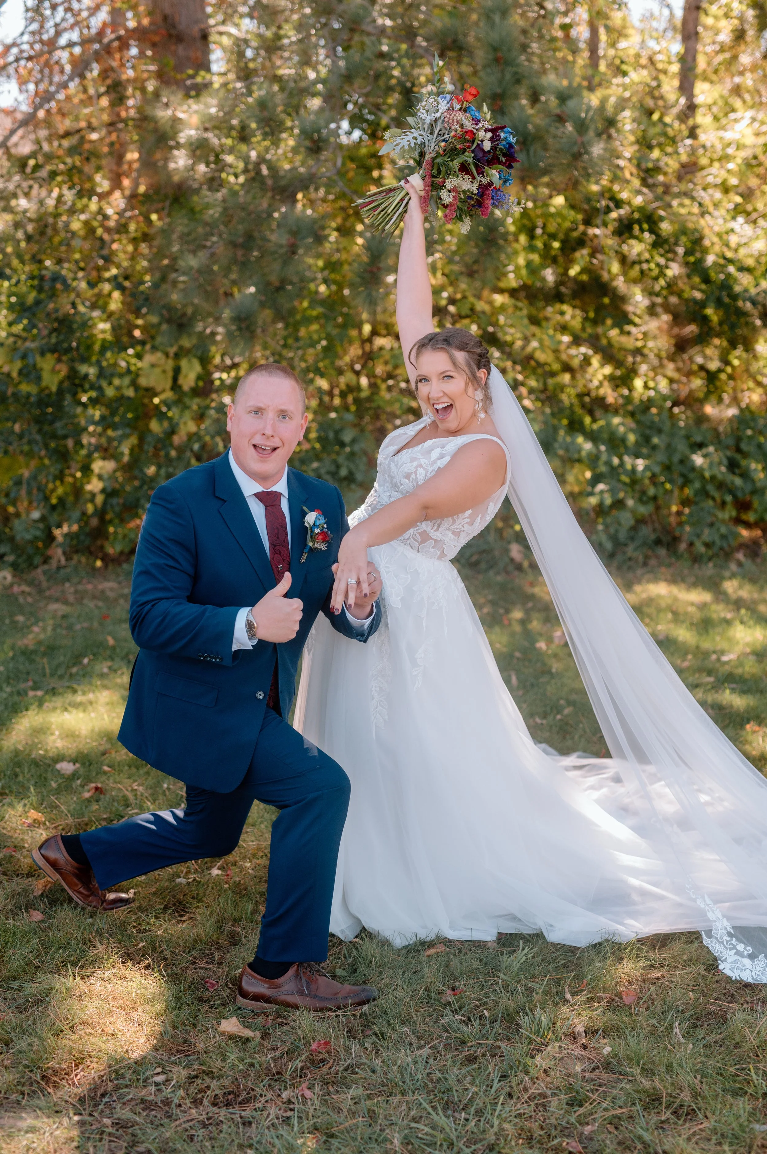 Bride and groom show off their rings and cheer as they celebrate their wedding at Stone Lion Winery and Events in Isanti, Minnesota