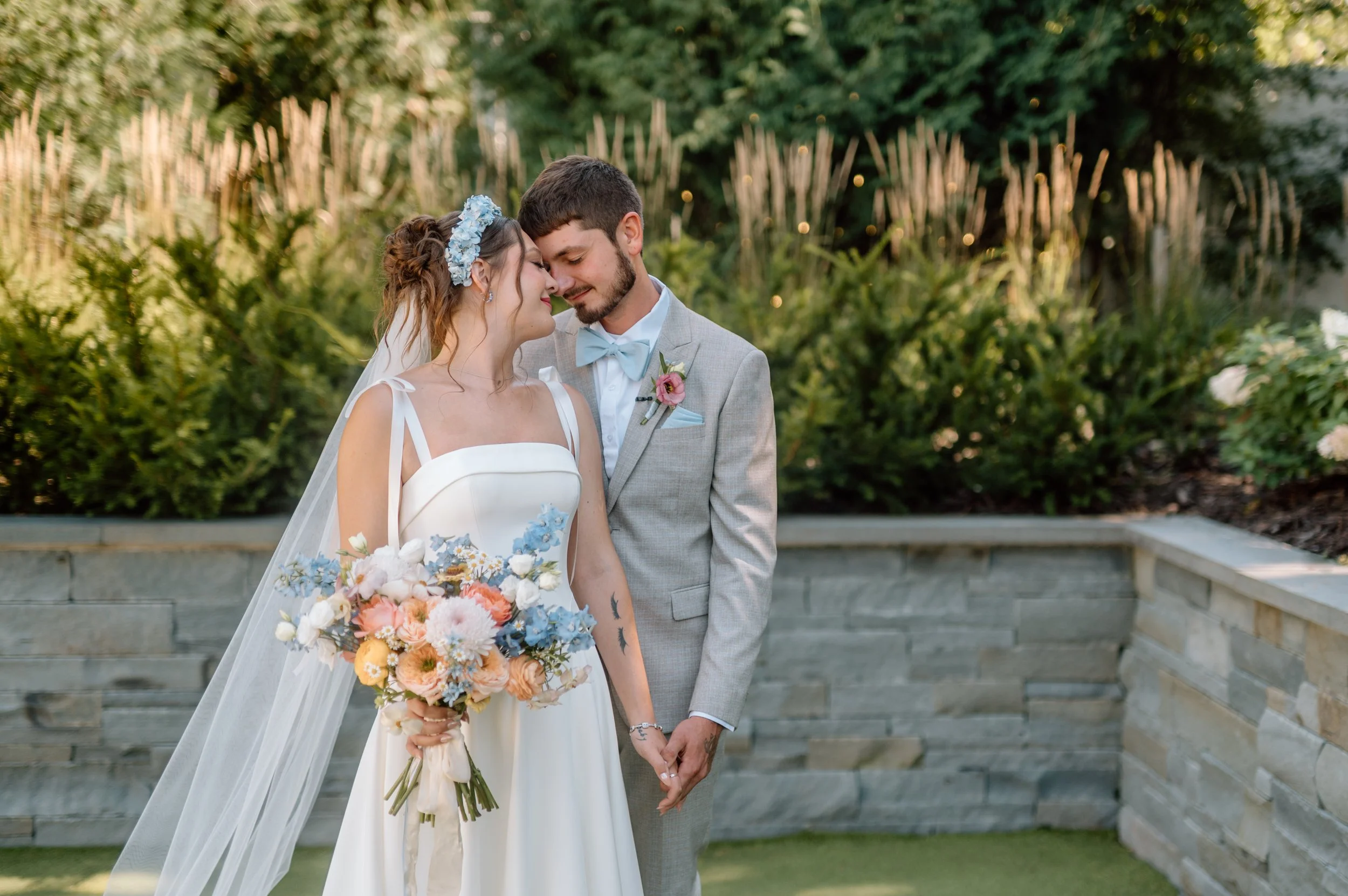 Bride and groom share a quiet moment together in the courtyard behind the Hutton House in Medicine Lake, MN