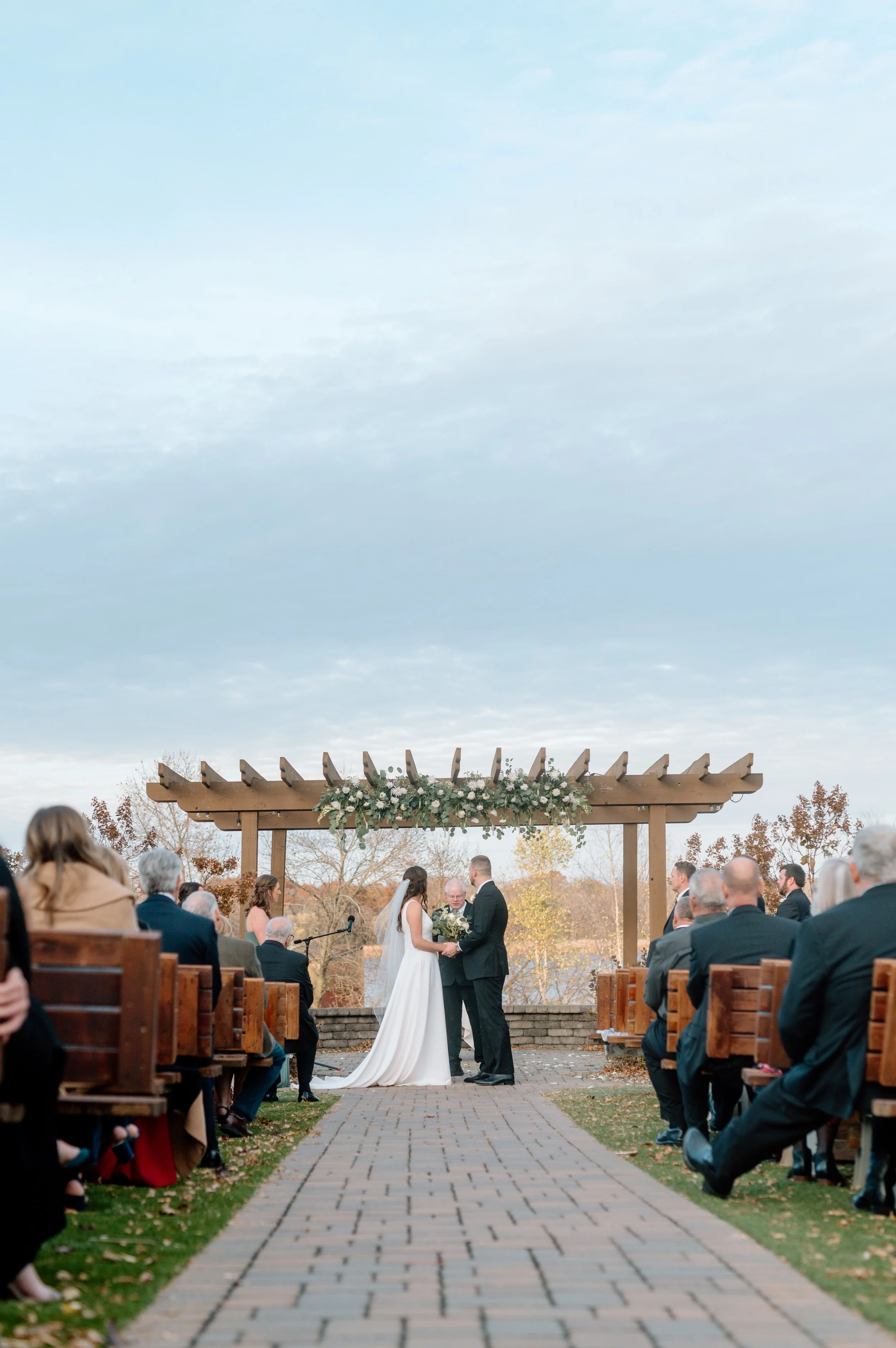 Ceremony at the Arbor at the Minnesota Horse and Hunt Club on a beautiful fall day as the bride and groom exchange vows