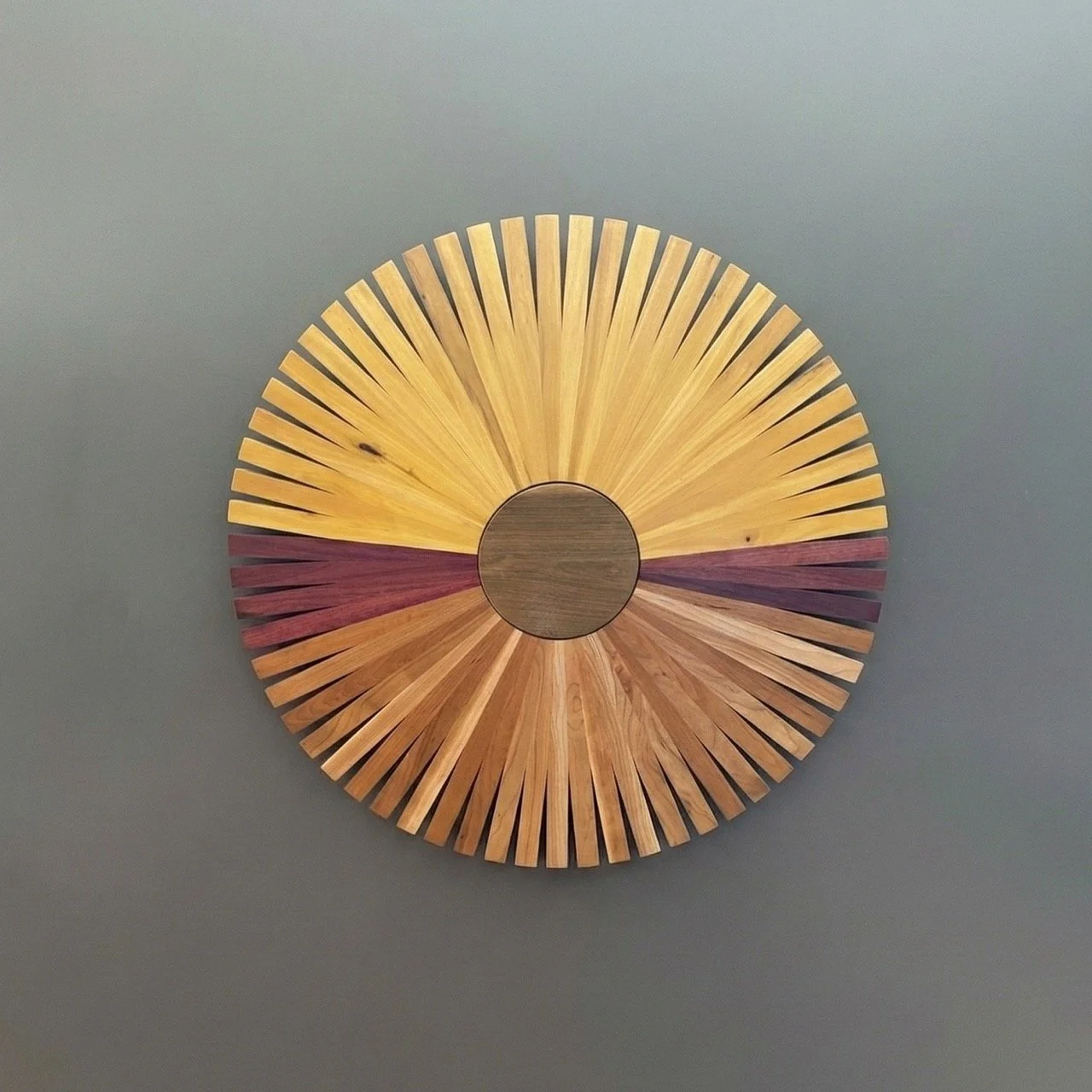 Art piece made of various species of wood slats arranged in a circle