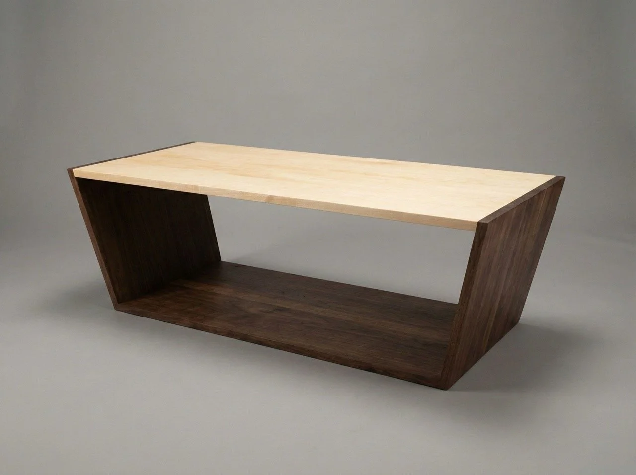 A trapezoid coffee table with a maple top