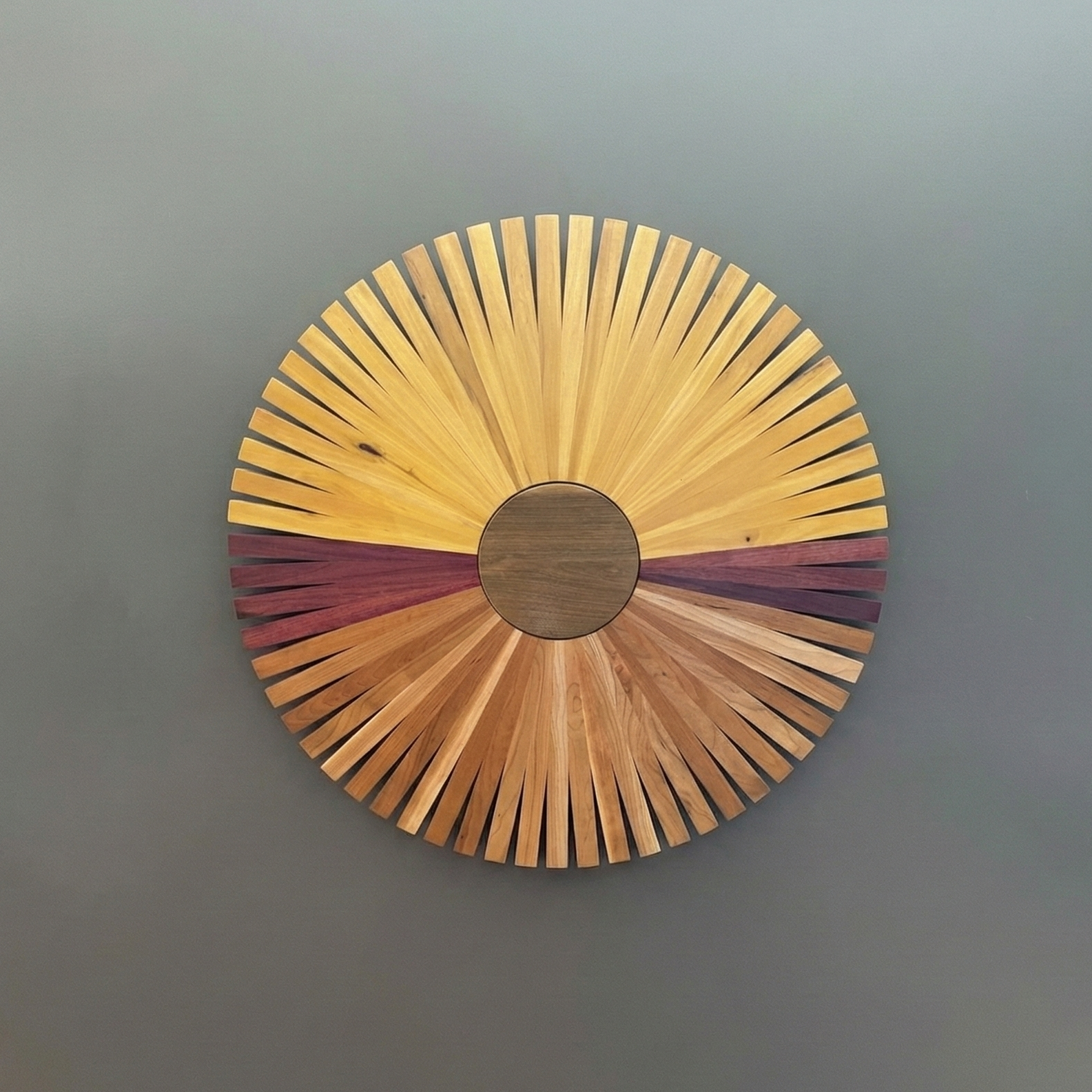 Art piece made of various species of wood slats arranged in a circle