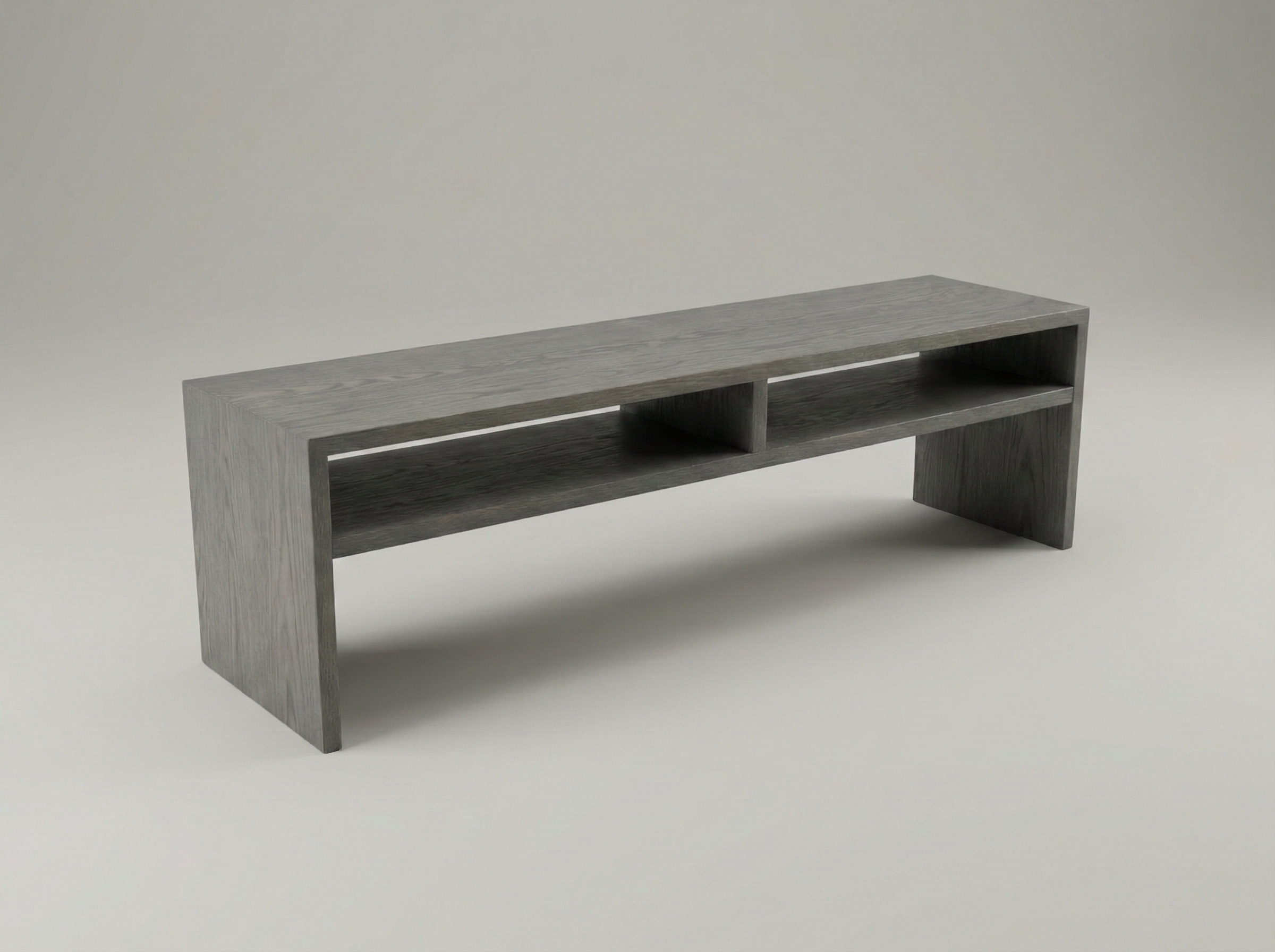 Long, low couch table made of ash and stained gray