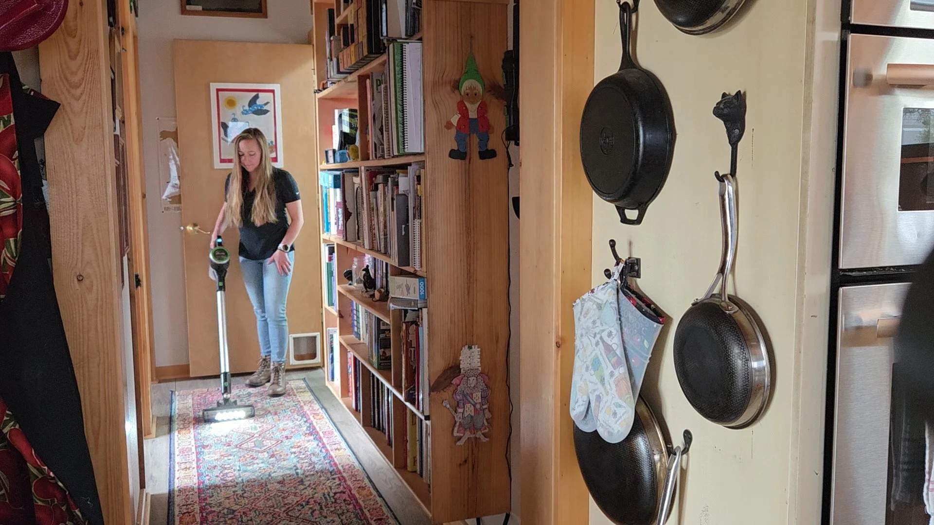 Charlie Payne of Jigsaw Animal Behavior and Welfare Consulting LLC, vacuuming and cleaning the home during a pet sitting visit