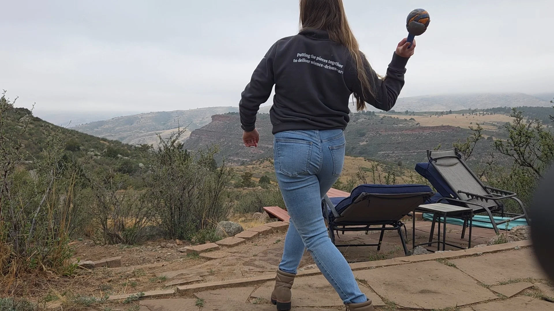 Charlie Payne of Jigsaw Animal Behavior and Welfare Consulting LLC throwing a ball for a dog during a pet sitting visit.