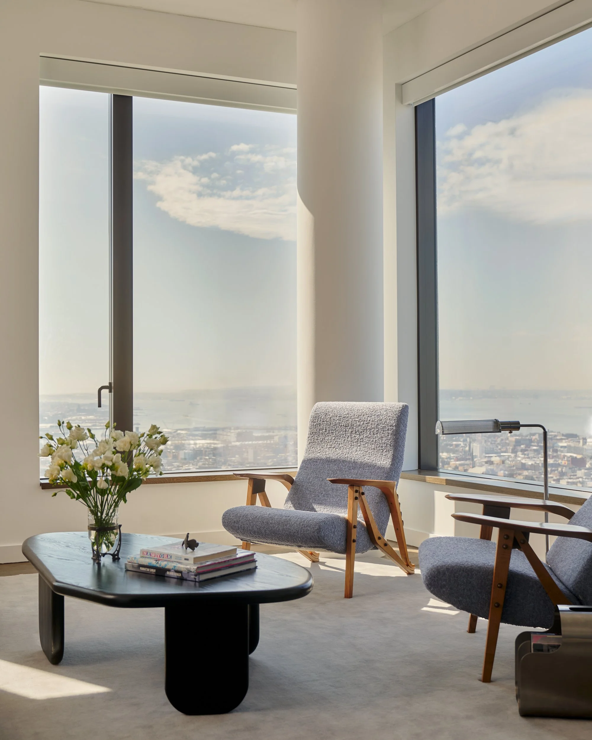Vintage chairs by Carlo Mollino offer the perfect place to sit and take in the sweeping skyline views. Interior Design by Gennett Studio.