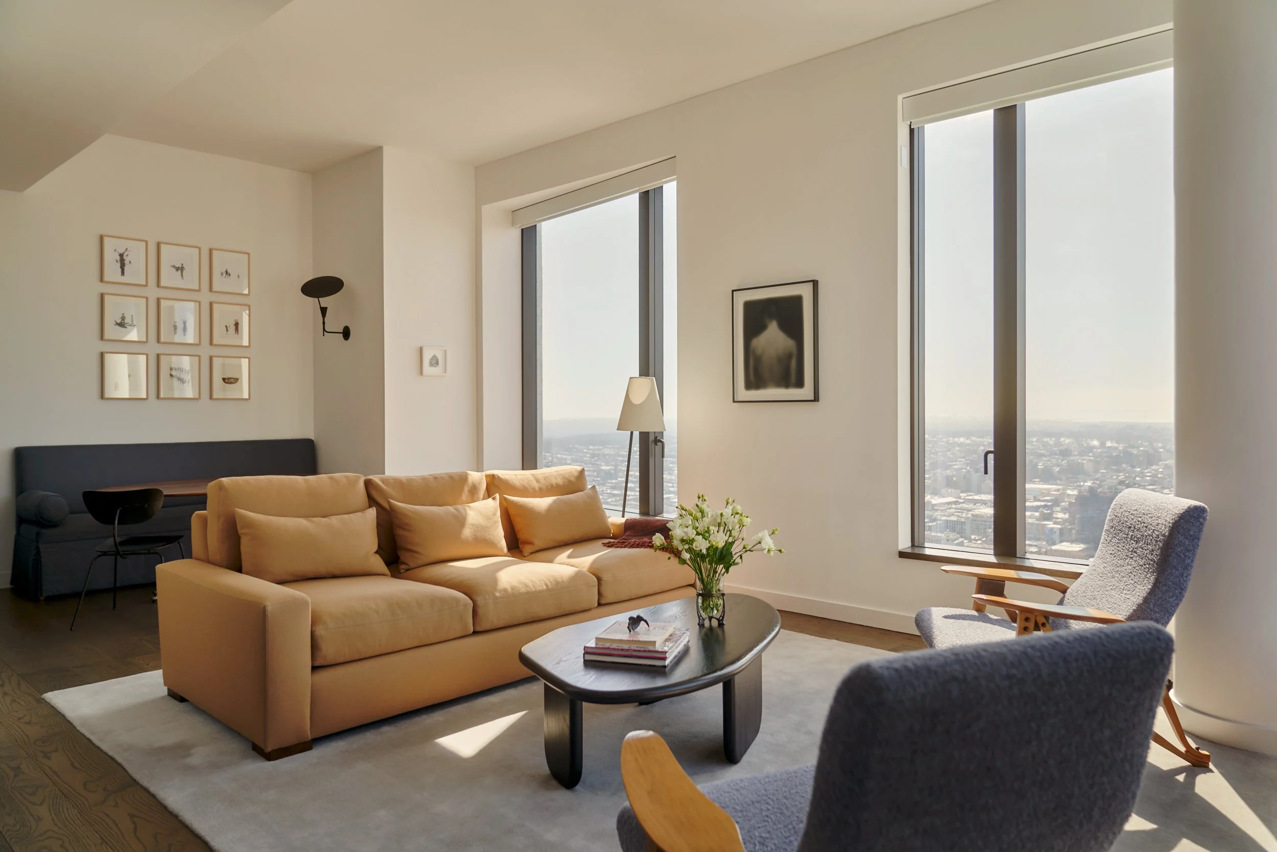 The sofa in Holland and Sherry fabric sits on a rug by  Nordic Knots, shaped to fit the angles of the space. Interior Design by Gennett Studio.
