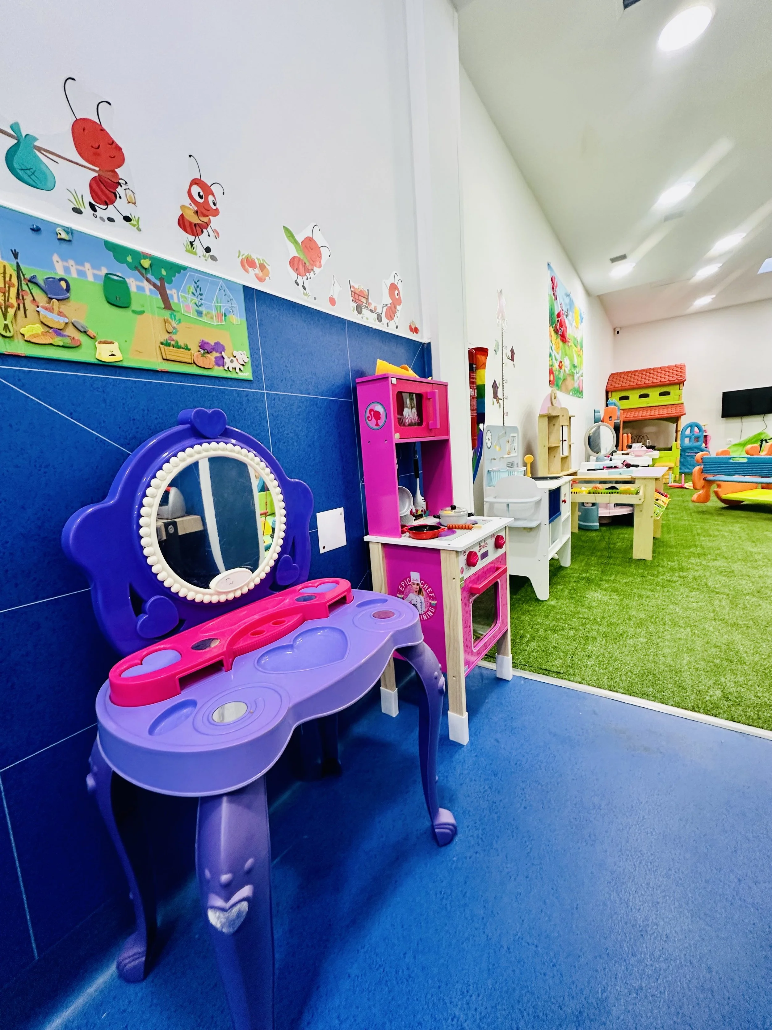 Área de brincadeiras criativas com cozinha e mesa de faz-de-conta no parque infantil Minh’Amora Fun Park 2 no Porto
