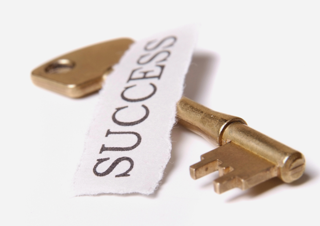 Gold key over a torn paper reading ‘Success’, symbolising systems as the key to business results.