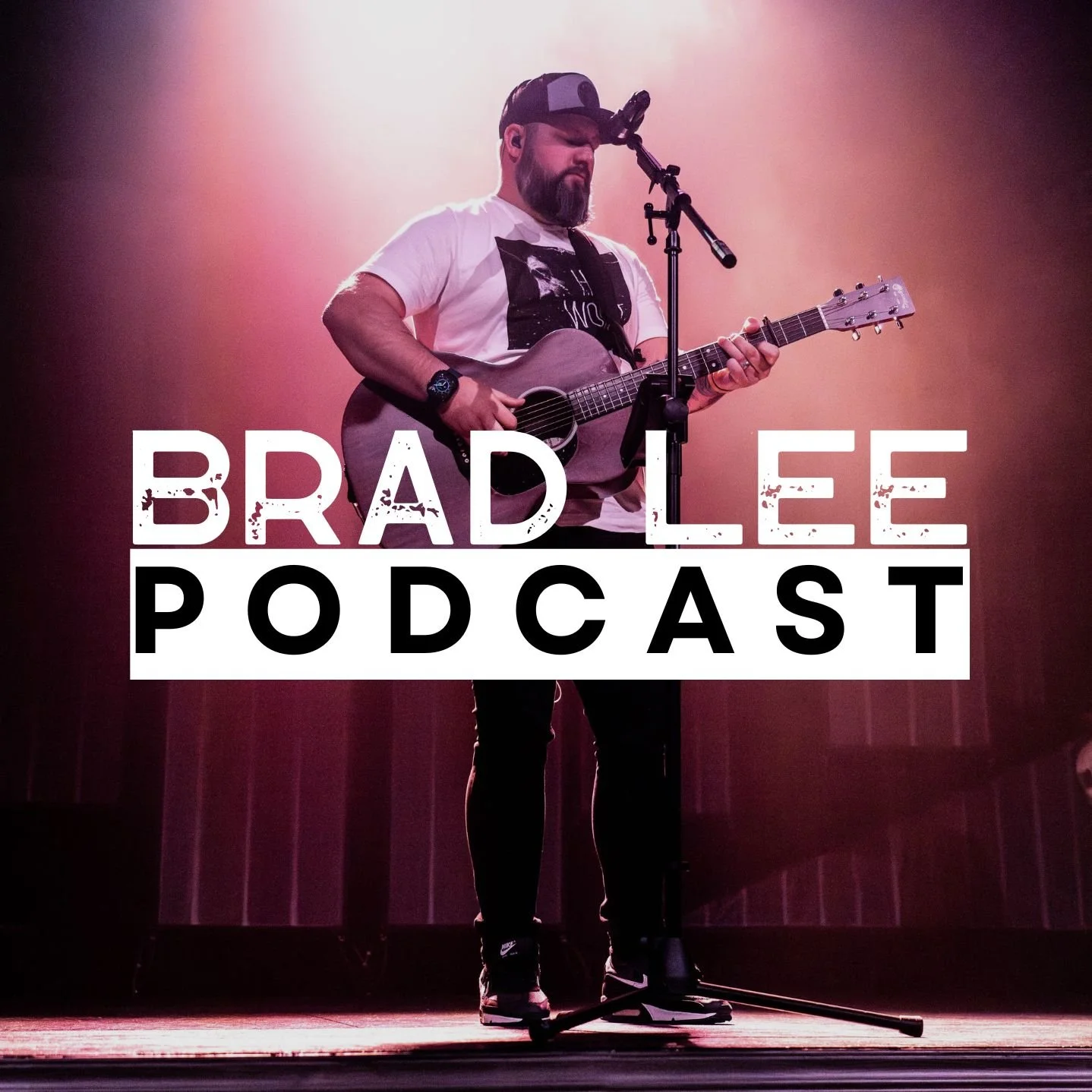 A man with a beard and cap playing acoustic guitar on stage with a microphone, with the text 'Brad Lee Podcast' overlaid.