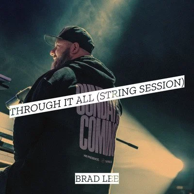Side view of a man with a beard wearing a black cap and hoodie, standing in a dimly lit room, with text overlay reading 'THROUGH IT ALL (STRING SESSION)' and 'BRAD LEE'.