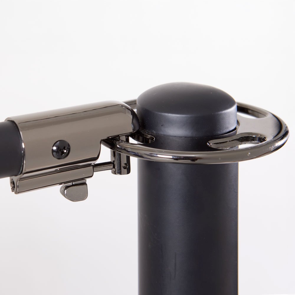 Close-up of a Ping Pong paddle hitting a black ping pong ball on a black stand.