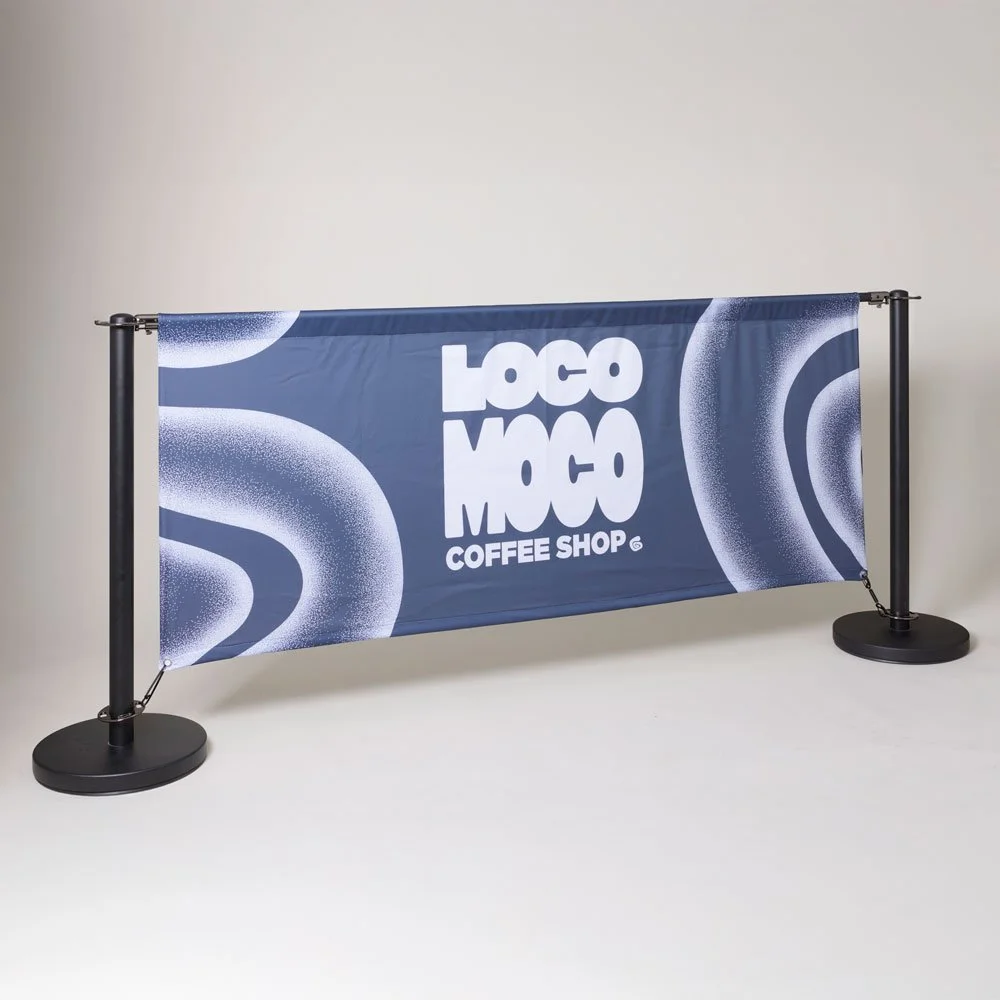 A blue fabric banner with abstract white and light blue patterns and the text 'LOCO MOCO COFFEE SHOP' displayed against a plain light background.