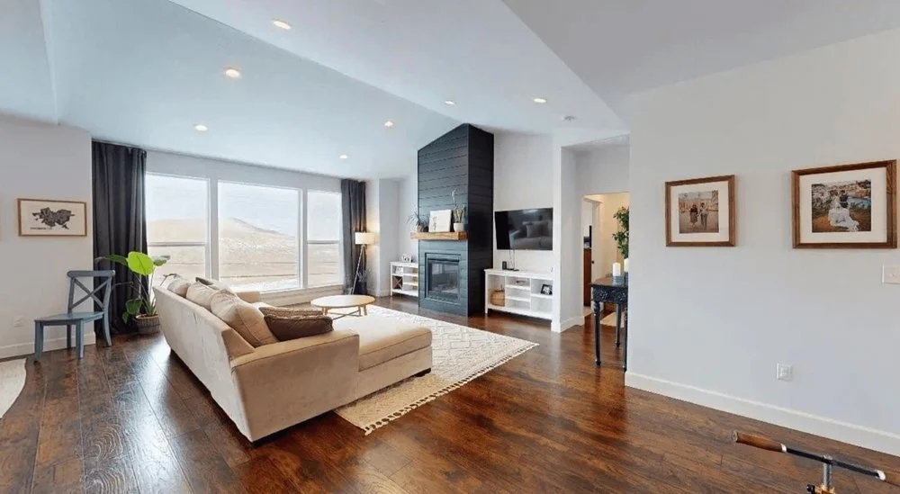 Open design concept in the family room with dark wood floors and black fireplace - Custom Home Builders WA - Diamond Homes