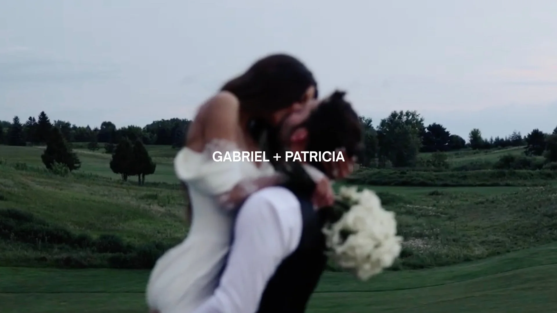 A couple hugging outdoors on a grassy landscape with trees and cloudy sky, with the text 'GABRIEL + PATRICIA' overlaid.