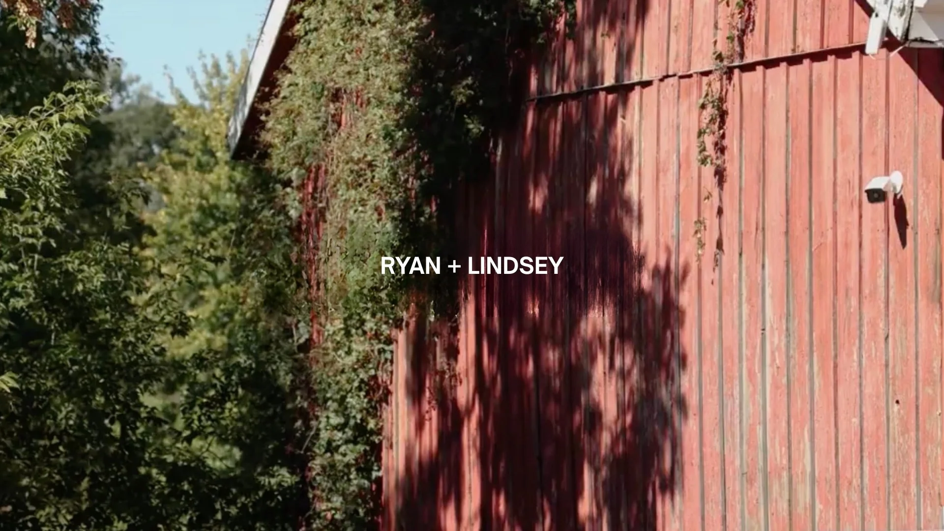 Image shows a wooden deck with shadow of trees. Text overlay says 'RYAN + LINDSEY'.