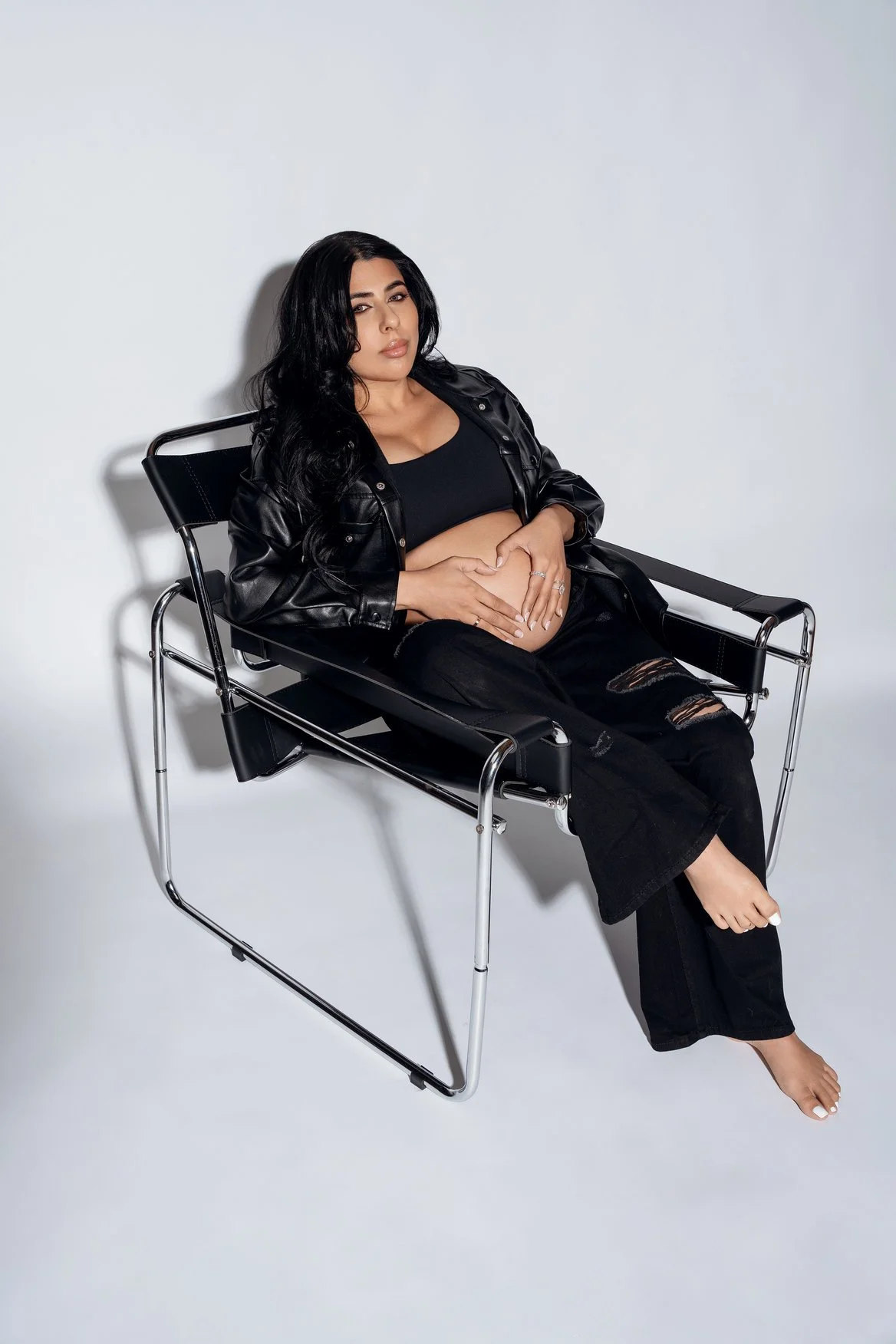 Maternity photoshoot with edgy black leather maternity pose in Chicago - Filaneyka photo studio