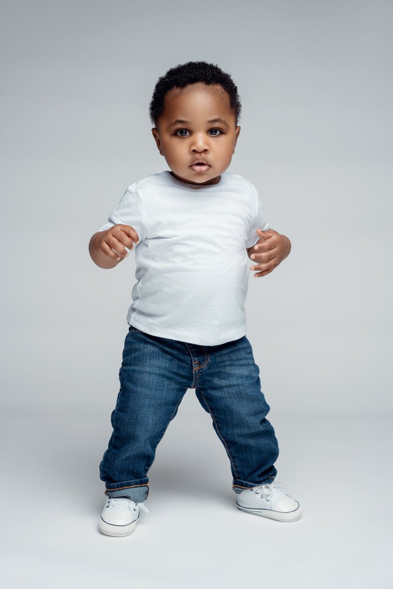 Baby milestone photoshoot with toddler boy standing in white tee and jeans in Chicago - Filaneyka photo studio
