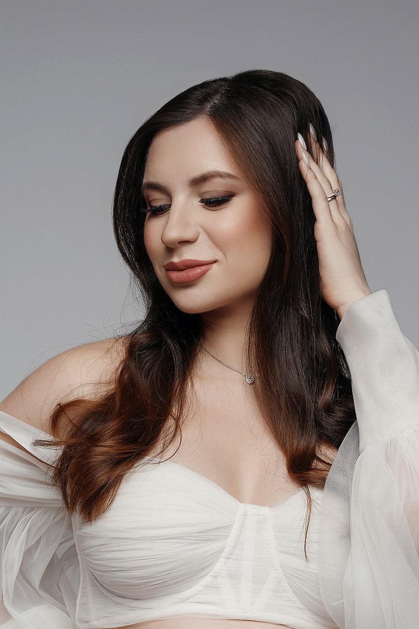 Styling and makeup session with brunette touching hair eyes closed in Chicago - Filaneyka photo studio