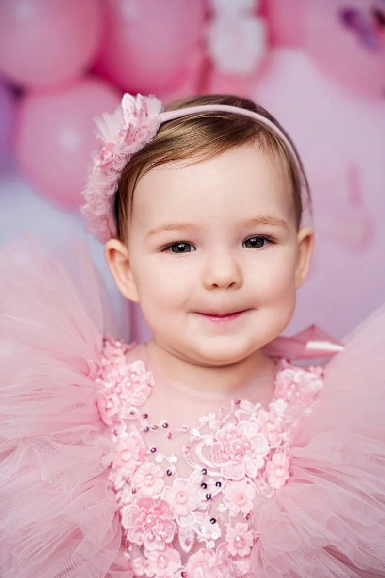 1st birthday photography with toddler girl closeup in pink floral dress in Chicago - Filaneyka photo studio