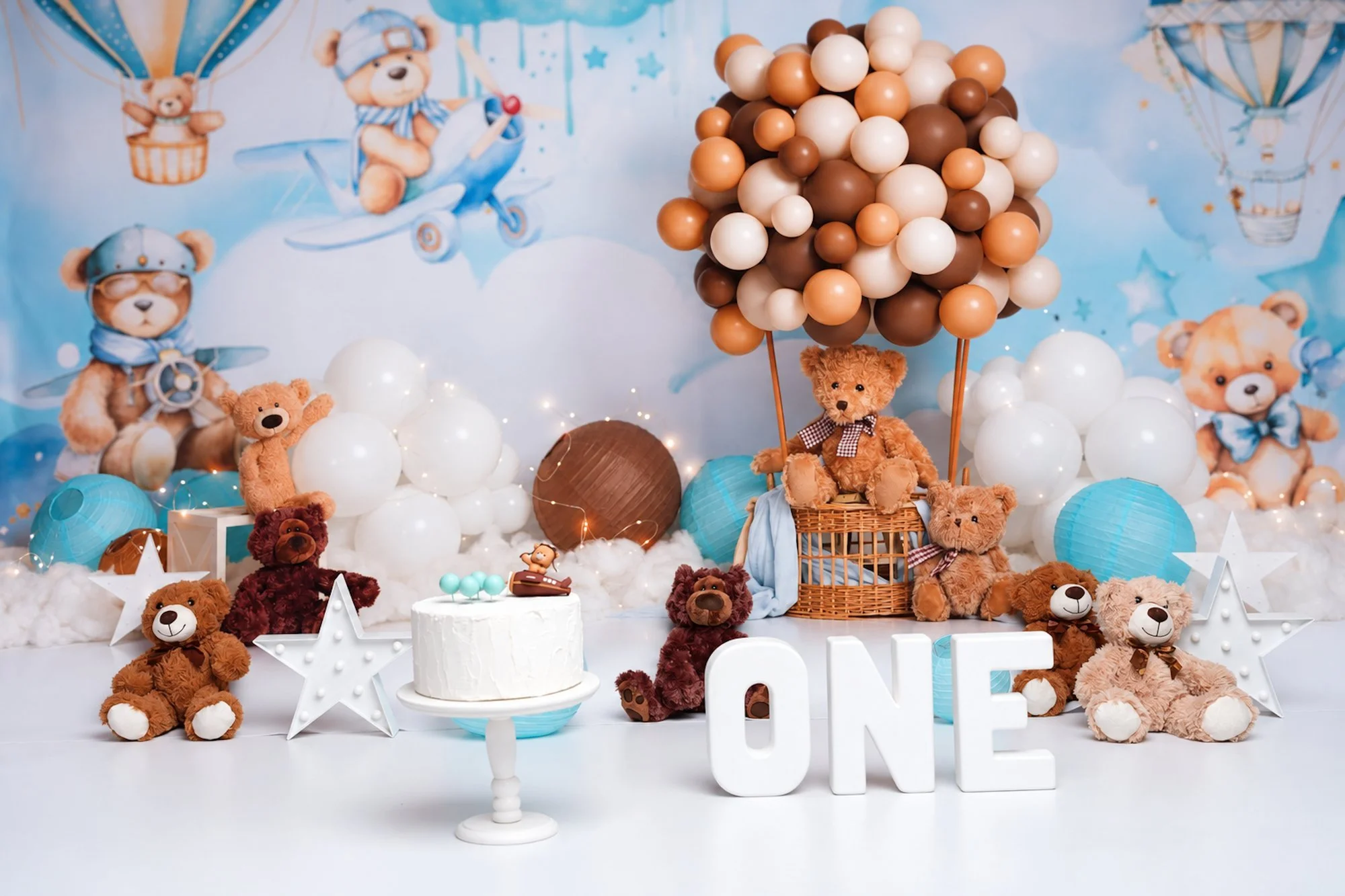 Teddy bear first birthday backdrop with ONE letters at a Chicago photo studio.