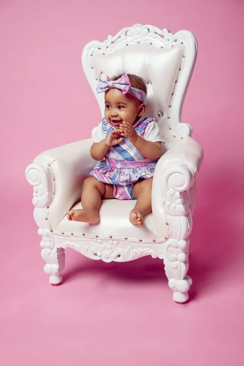 Baby milestone photoshoot with baby on white throne with pink background in Chicago - Filaneyka photo studio