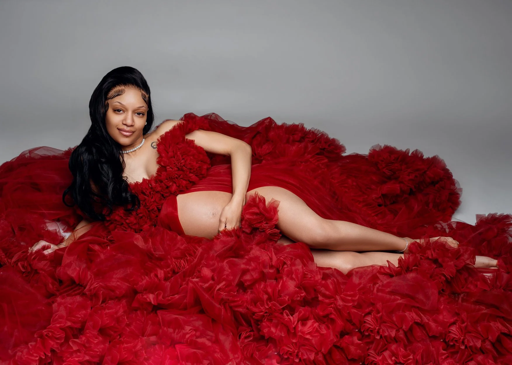 Maternity photoshoot with glamorous red gown maternity pose in Chicago - Filaneyka photo studio