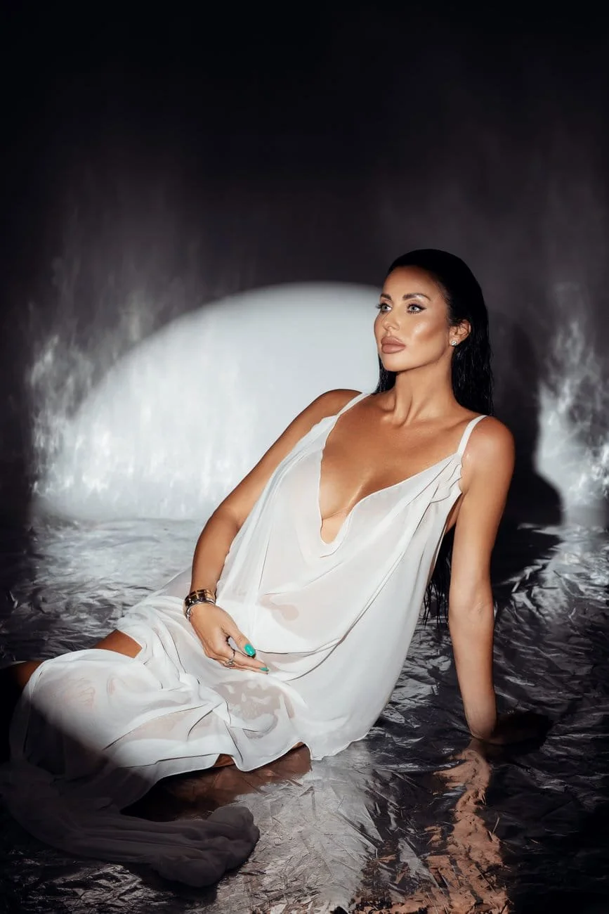 Prenatal photography session with seated white dress moody lighting in Chicago - Filaneyka photo studio