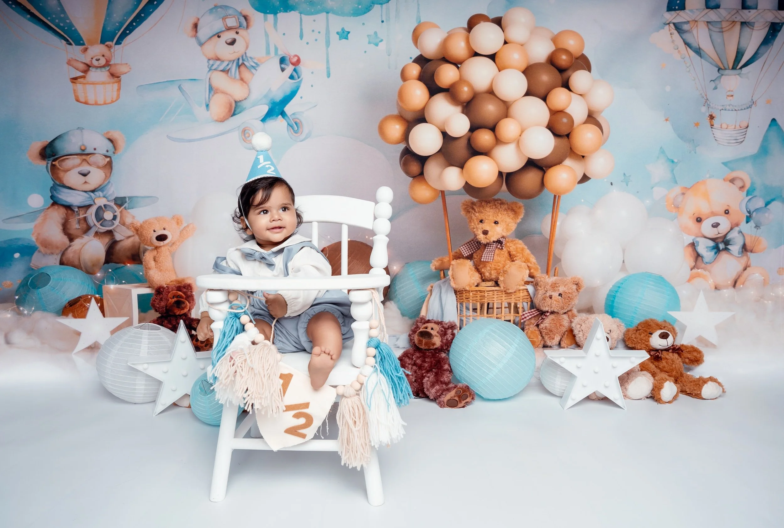 6-month baby boy half-birthday portrait in a teddy bear themed studio set with blue balloons, Filaneyka Photo Studio Chicago