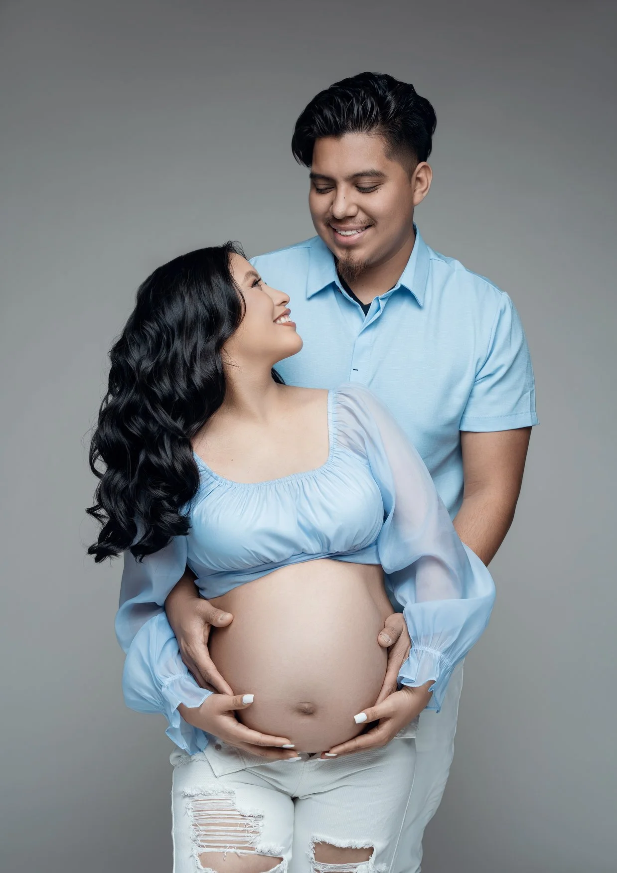 Maternity portrait session with couple in blue smiling in Chicago - Filaneyka photo studio
