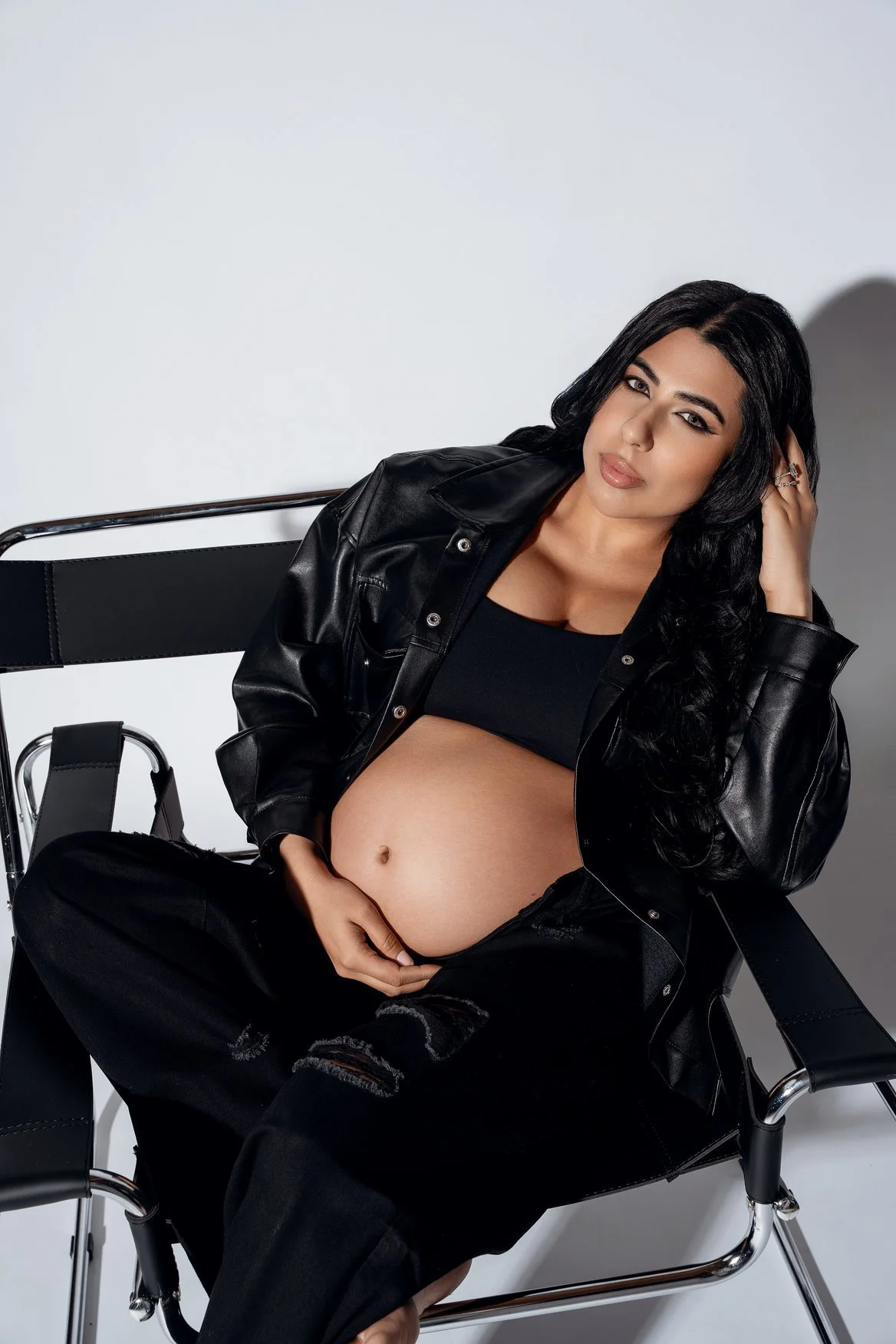 Maternity portrait session with black leather seated maternity portrait in Chicago - Filaneyka photo studio