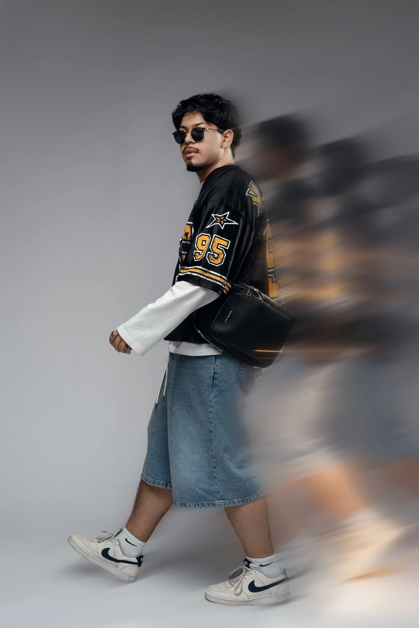 Boutique portrait session: man in casual streetwear posing in a studio