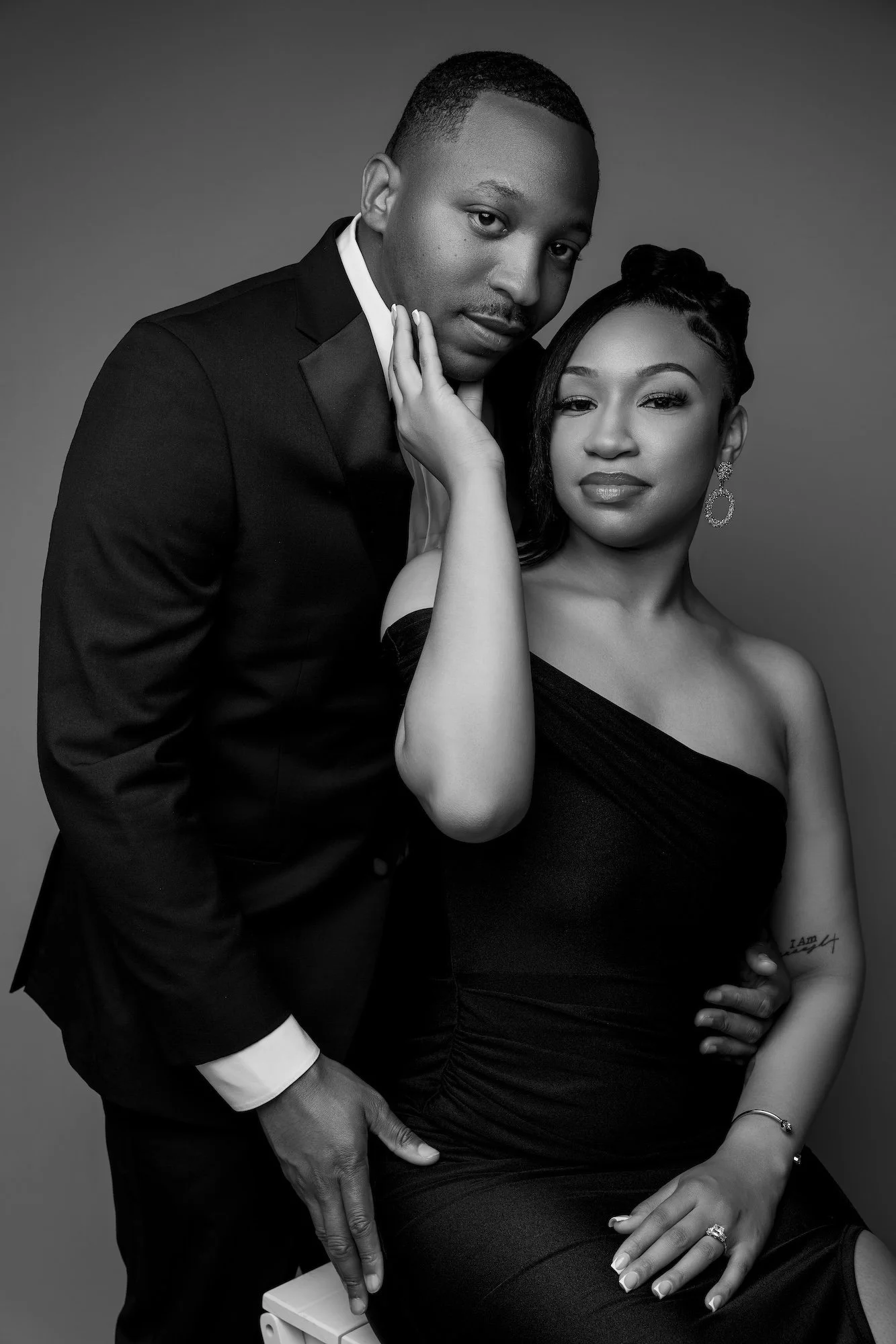 Black and white intimate engagement photo, woman touching man's face, romantic studio portrait at Filaneyka Chicago