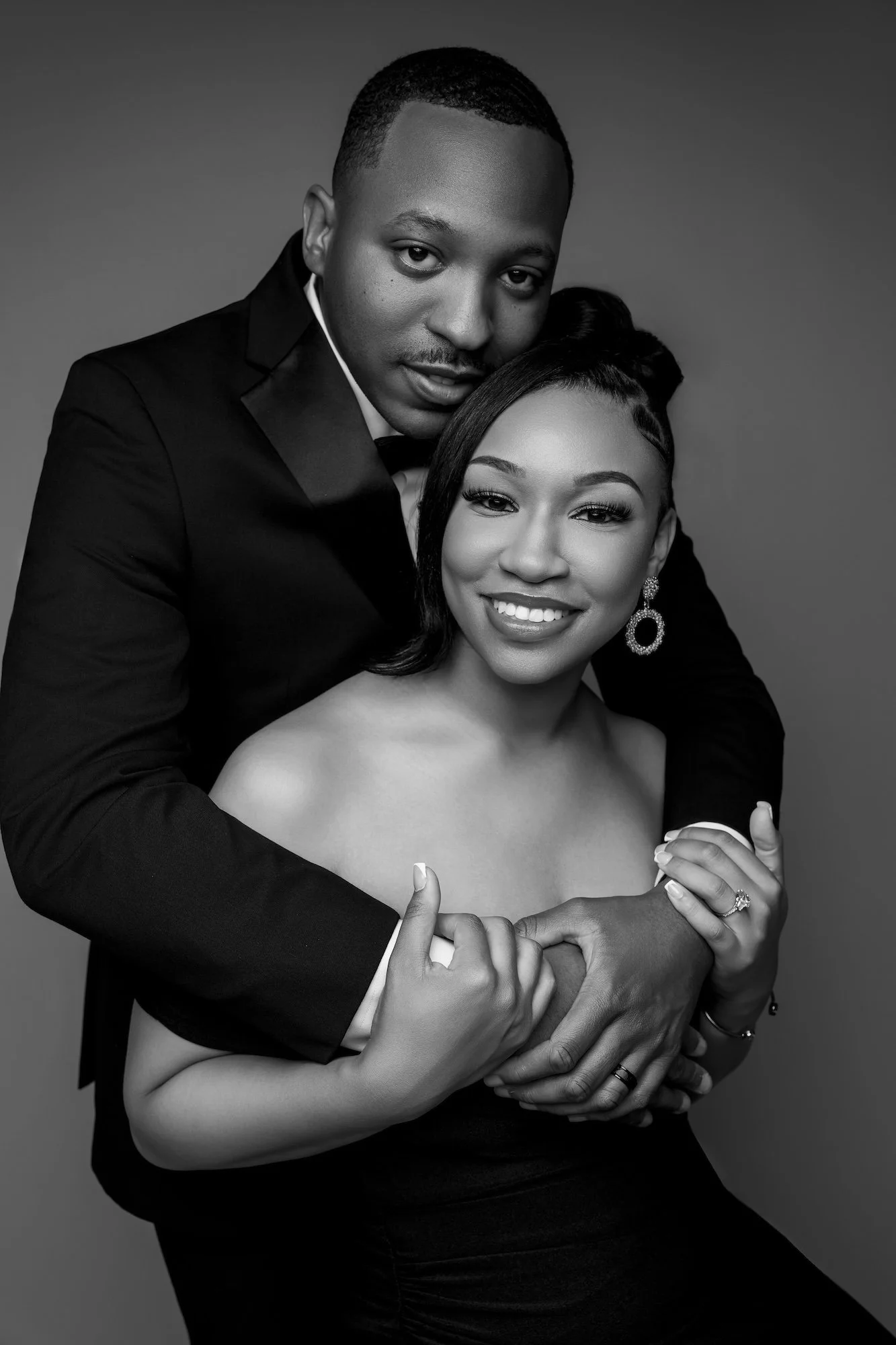 Black and white engagement couple embracing, warm-toned intimate portrait at Filaneyka Photo Studio Chicago