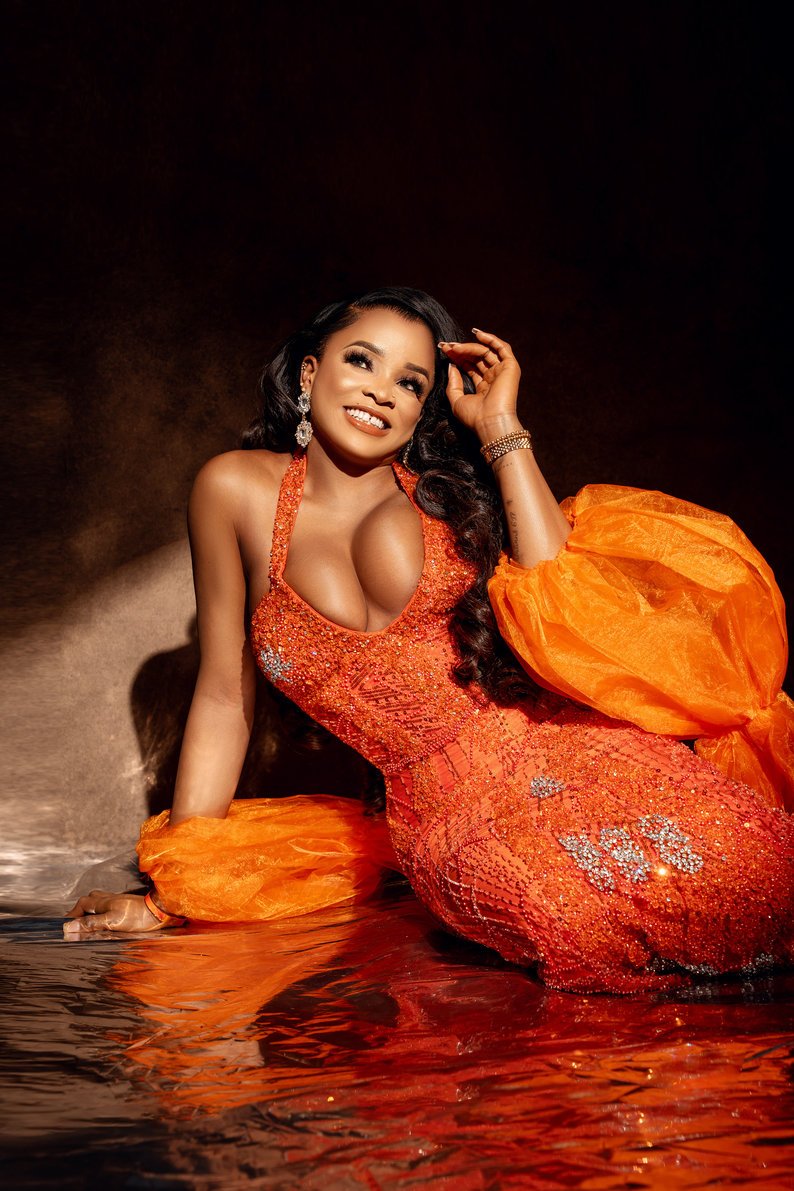 Professional portrait session with orange gown in water smiling in Chicago - Filaneyka photo studio