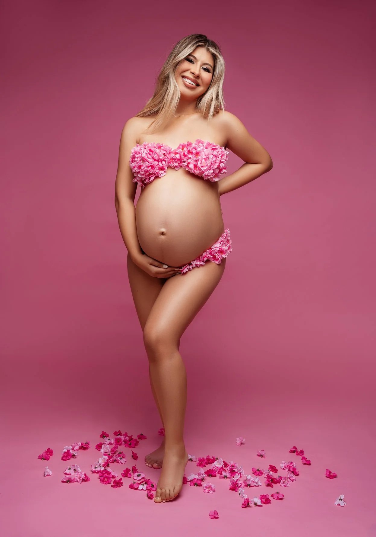 Prenatal photography session with pink petals pregnancy portrait standing in Chicago - Filaneyka photo studio