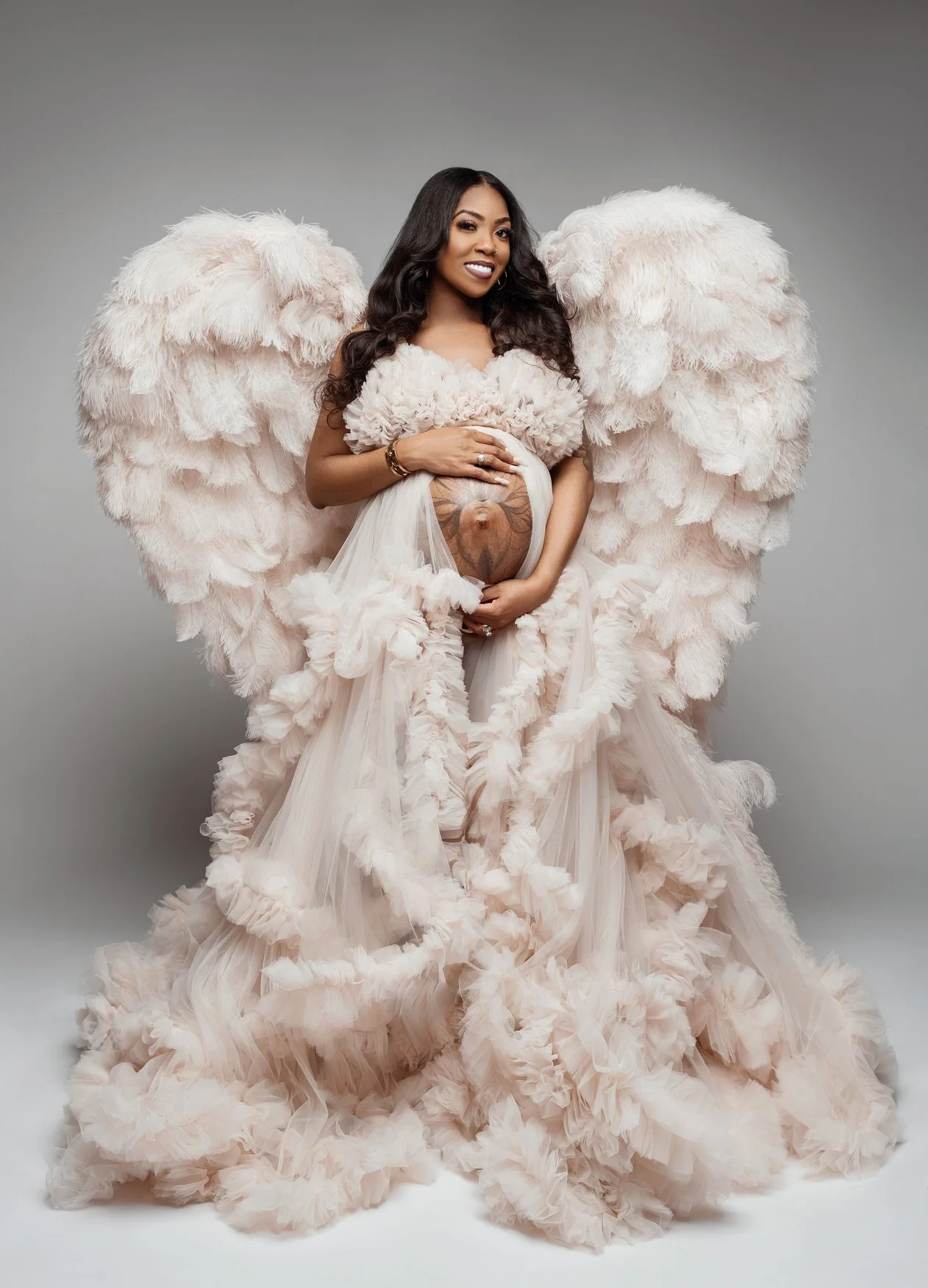 Expecting mother photoshoot with pink feathered angelic maternity in Chicago - Filaneyka photo studio