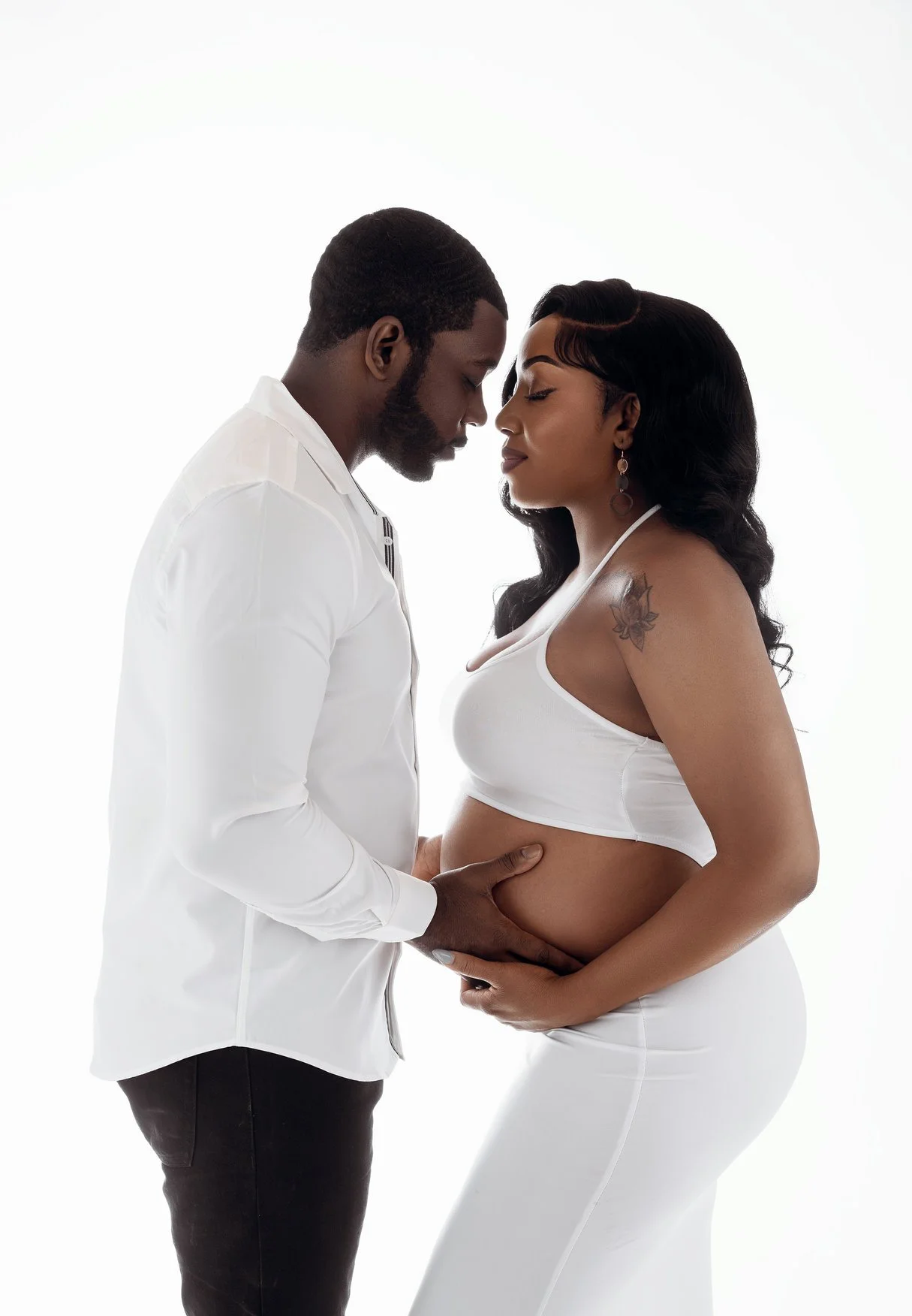 Maternity portrait session with couple in white touching belly in Chicago - Filaneyka photo studio