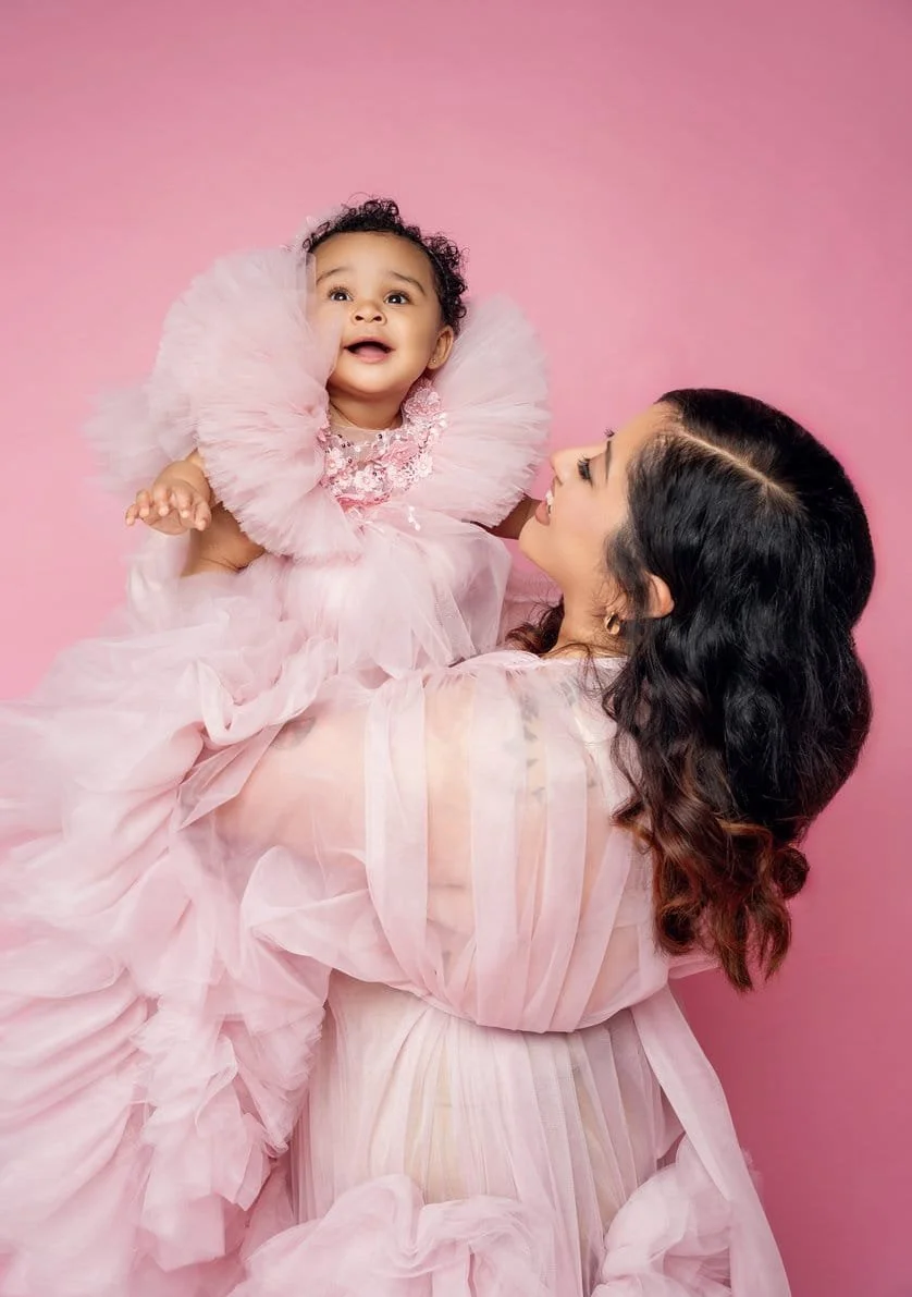 Cake smash session with mother lifting baby in pink dresses in Chicago - Filaneyka photo studio