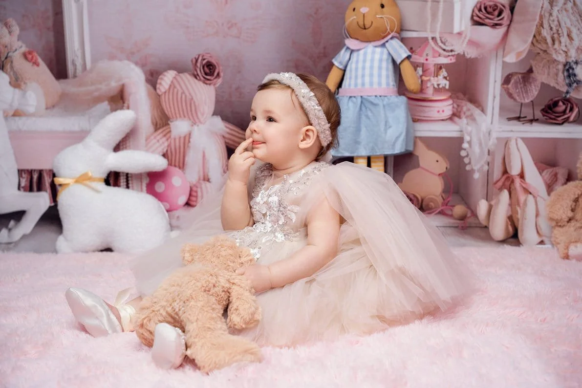 Baby milestone photoshoot with toddler with teddy bear in pink room in Chicago - Filaneyka photo studio