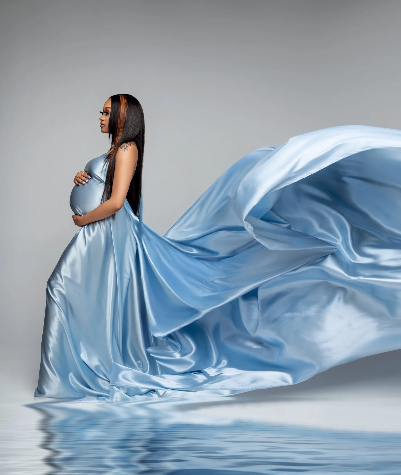 Maternity photoshoot with blue satin gown on water in Chicago - Filaneyka photo studio