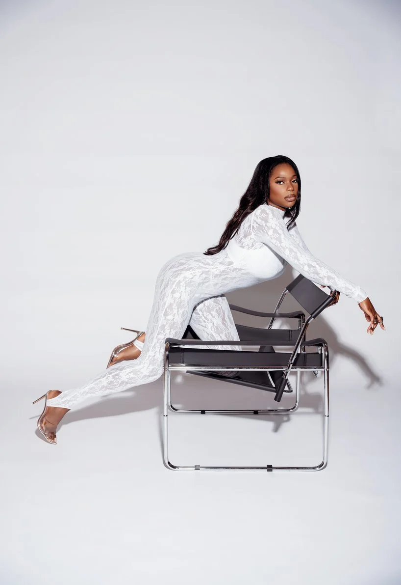 Professional portrait session with woman posing over modern chair in Chicago - Filaneyka photo studio