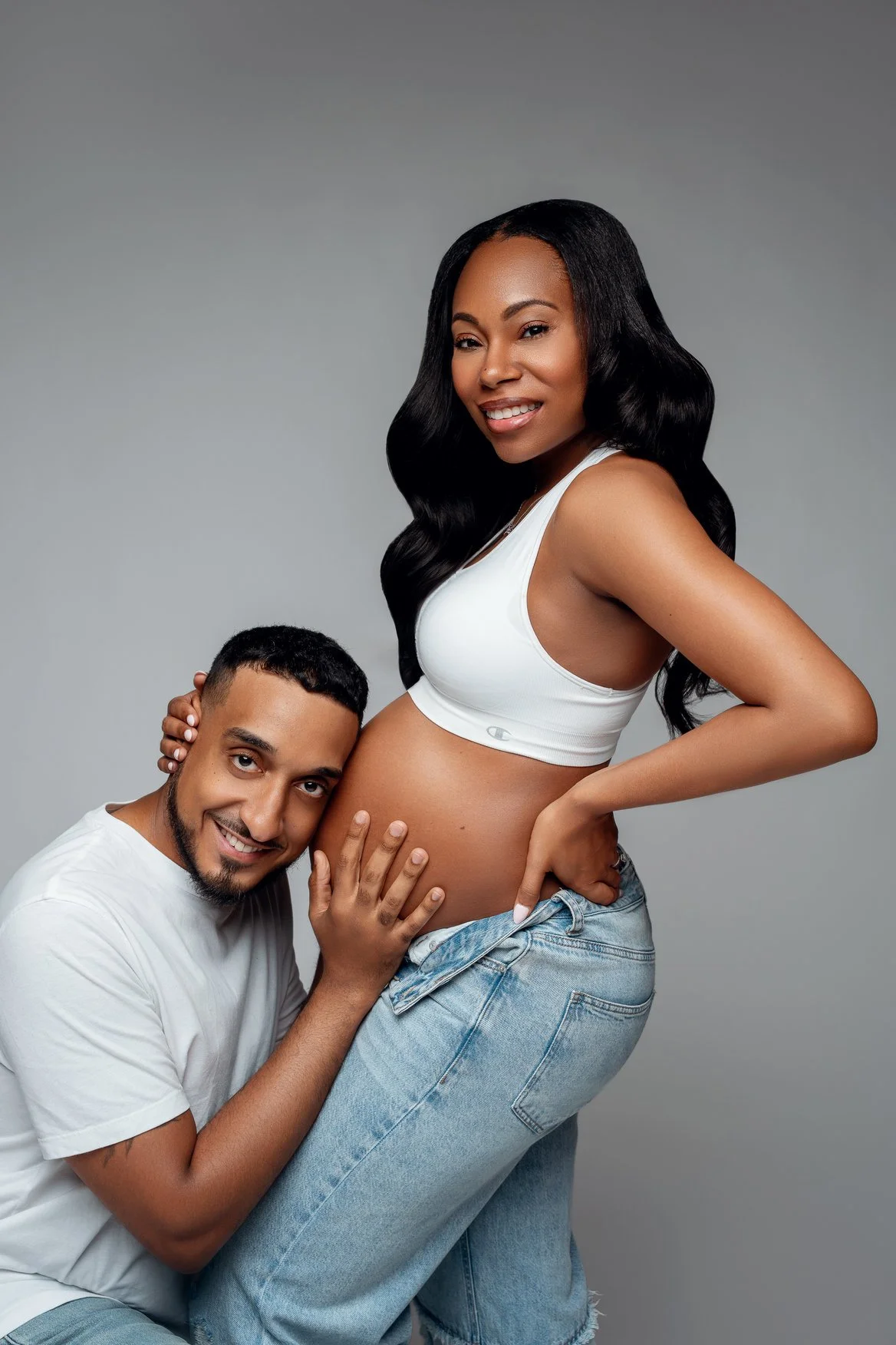 Pregnancy photography with partner embracing pregnant belly in Chicago - Filaneyka photo studio
