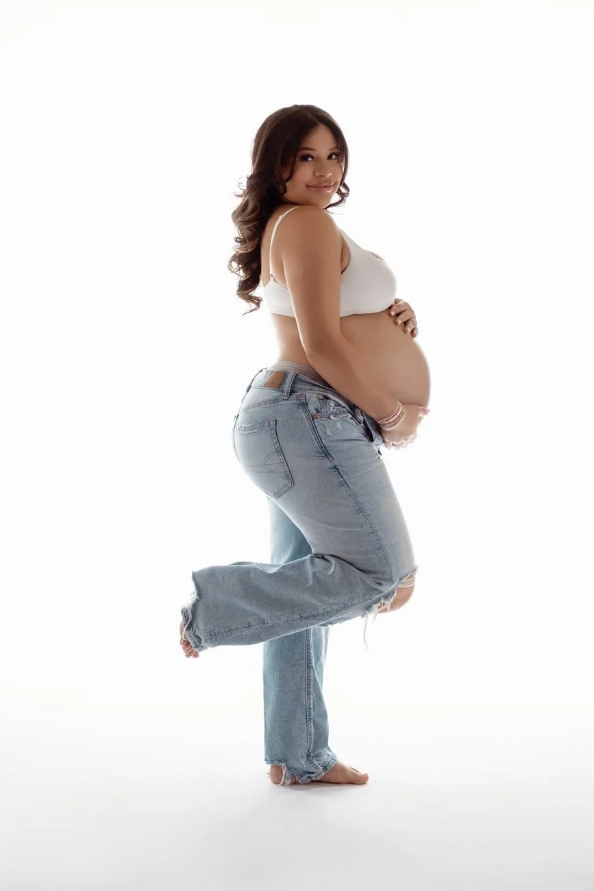 Prenatal photography session with casual jeans pregnant playful pose in Chicago - Filaneyka photo studio
