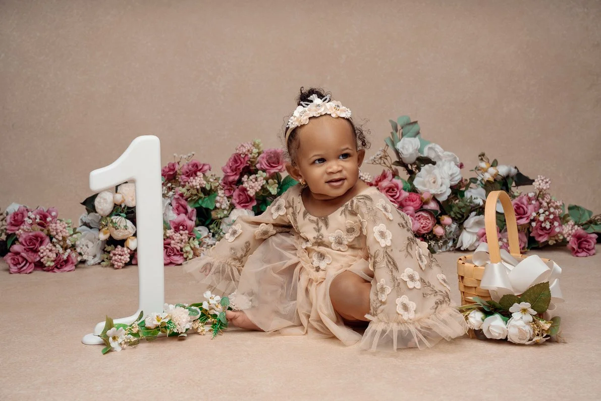 First birthday portrait with baby girl sitting with floral backdrop crown in Chicago - Filaneyka photo studio