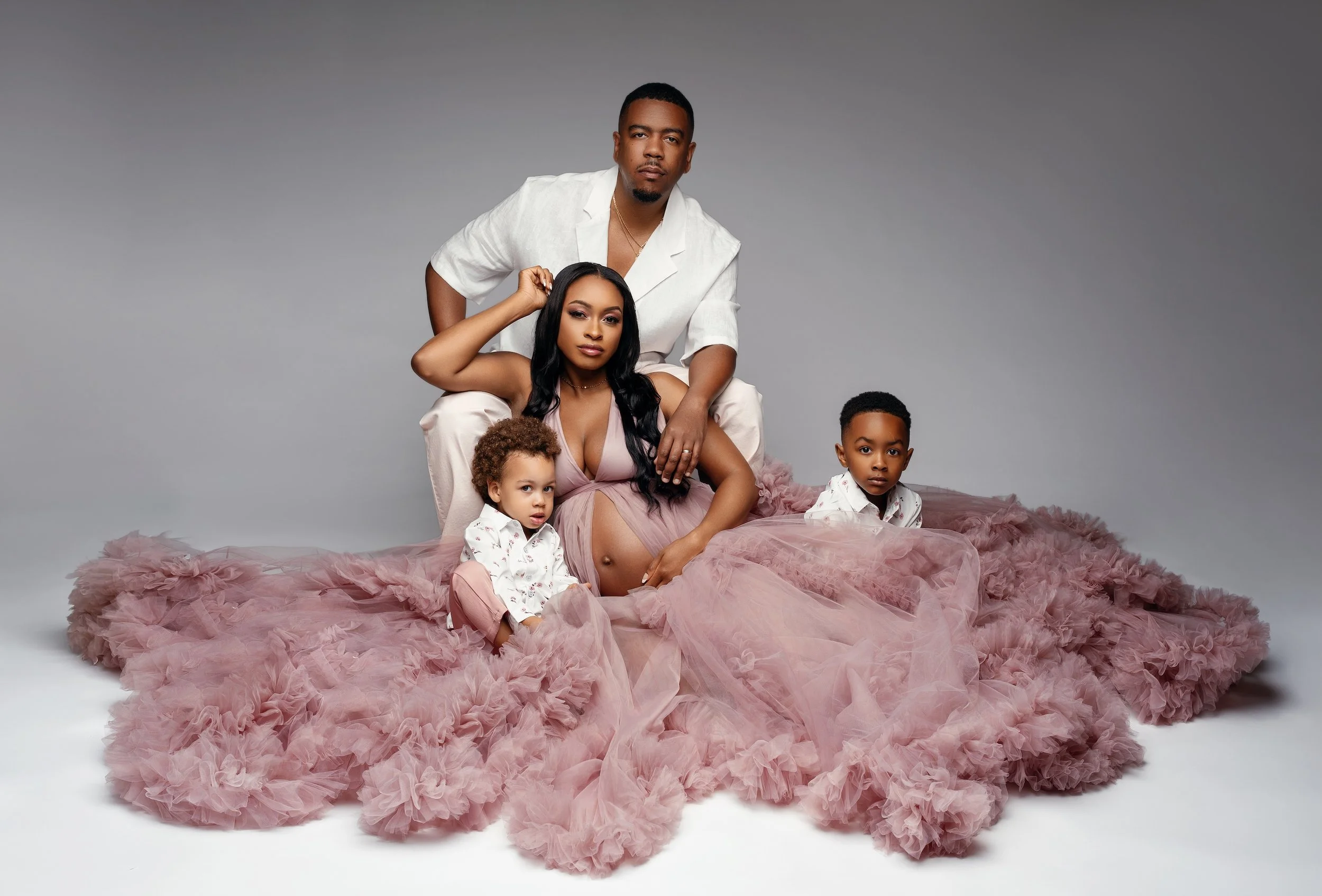 Classic maternity session: family portrait with the woman in a dusty rose tulle gown