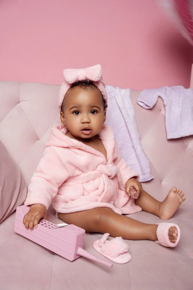 1st birthday photography with baby girl in pink robe spa themed in Chicago - Filaneyka photo studio